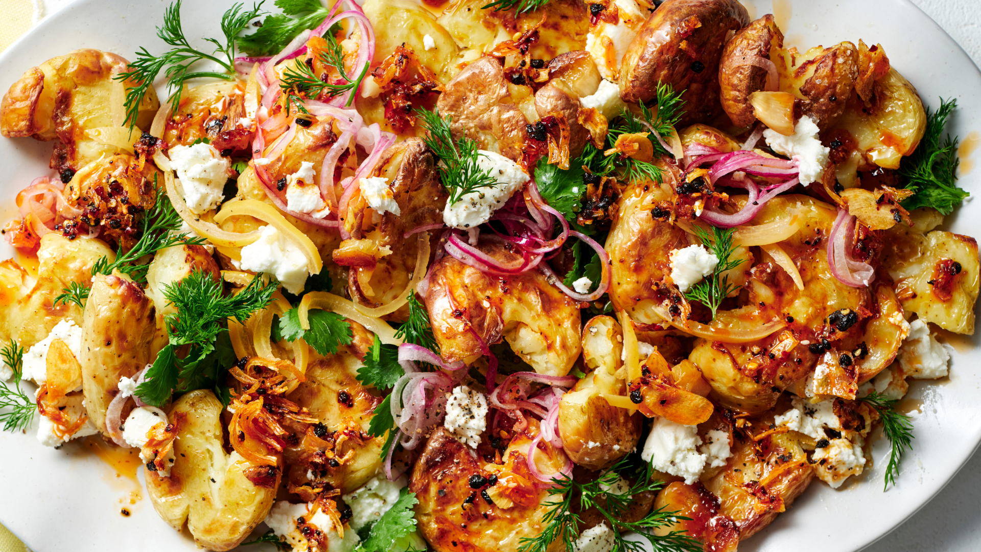 Crunchy chilli and lemon potatoes with goat’s cheese