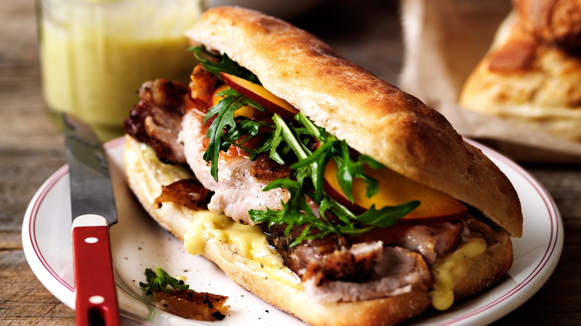 Porchetta, crackling and nectarine relish on ciabatta