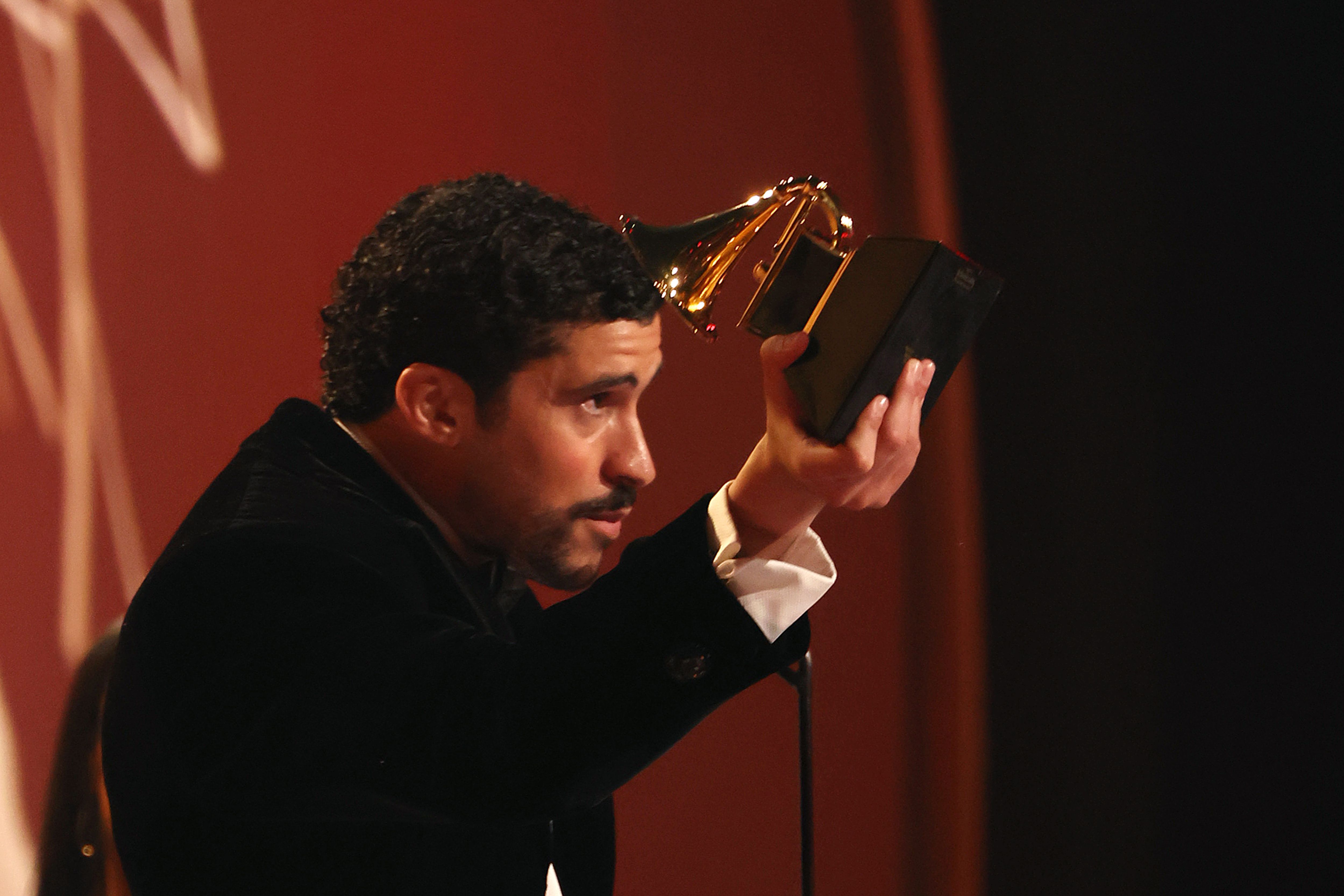 Bad Bunny accepts the album of the year award.