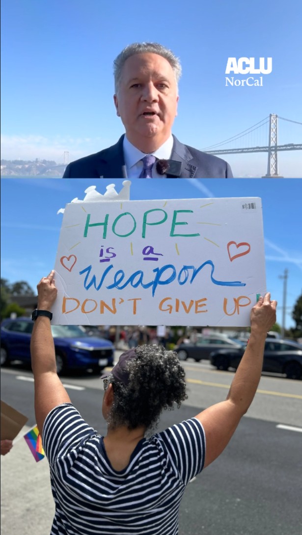 A person holding a sign that reads, 'Hope is a weapon, don't give it up'