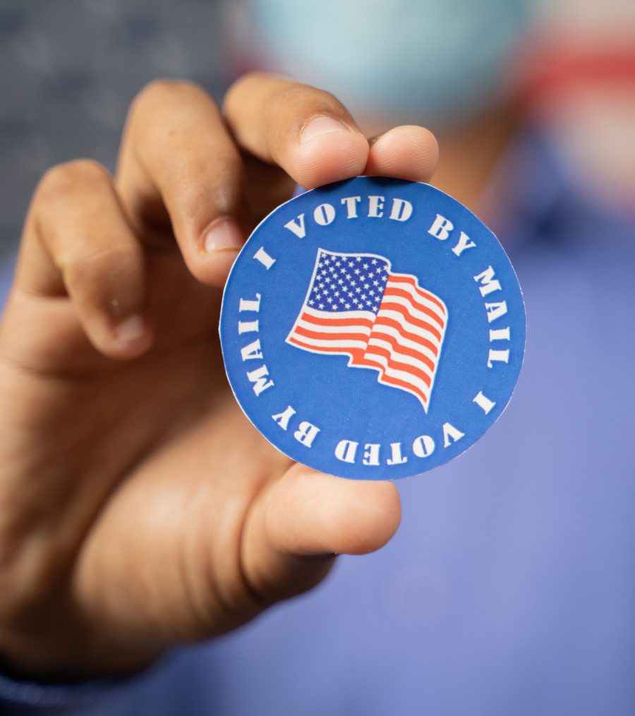 Image of a vote by mail sticker.