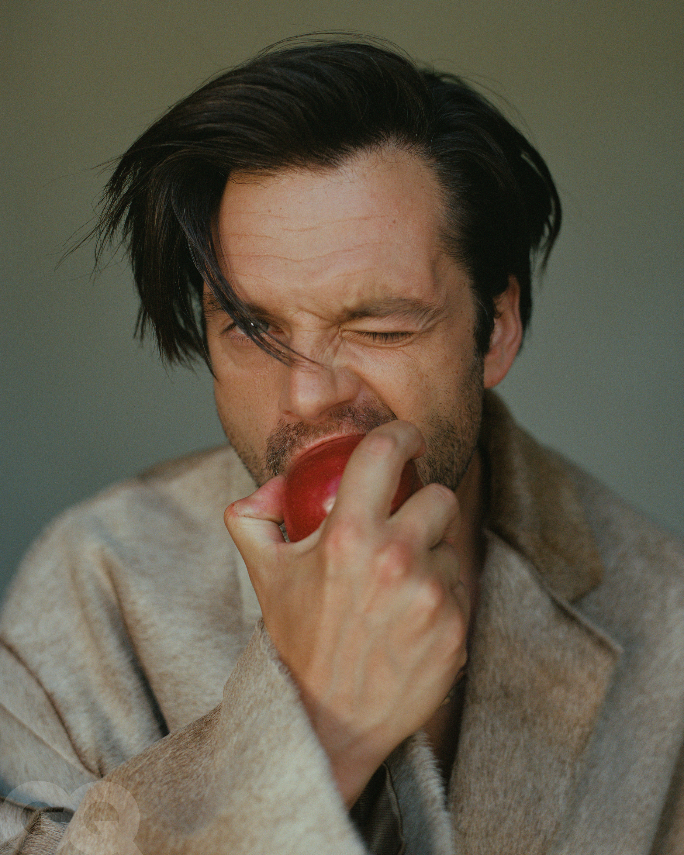 Image may contain: Sebastian Stan, Face, Head, Person, Photography, Portrait, Clothing, Coat, Adult, Accessories, and Jewelry
