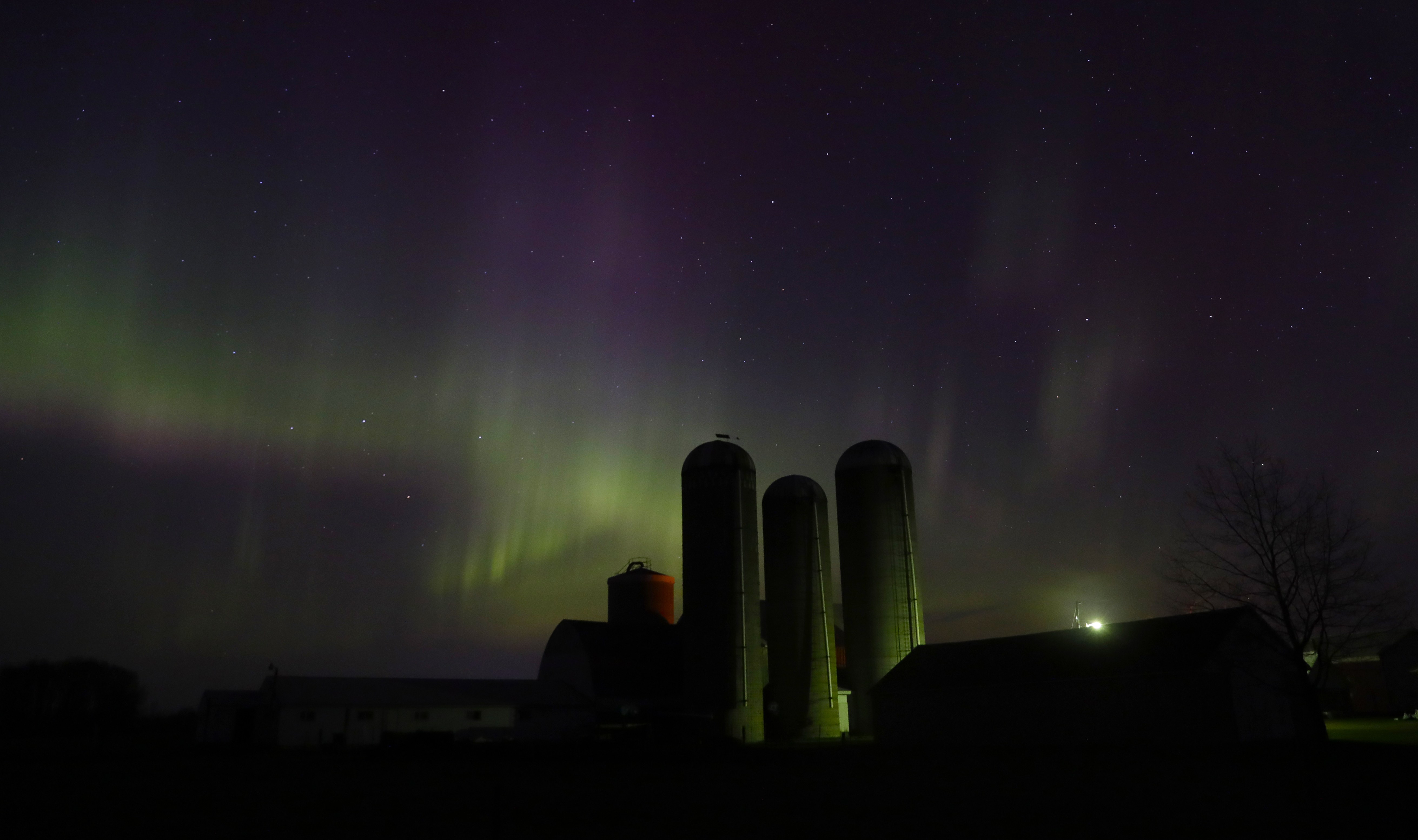 The northern lights are seen over a farm near Pulaski, Wis., on Sunday, April 23, 2023.