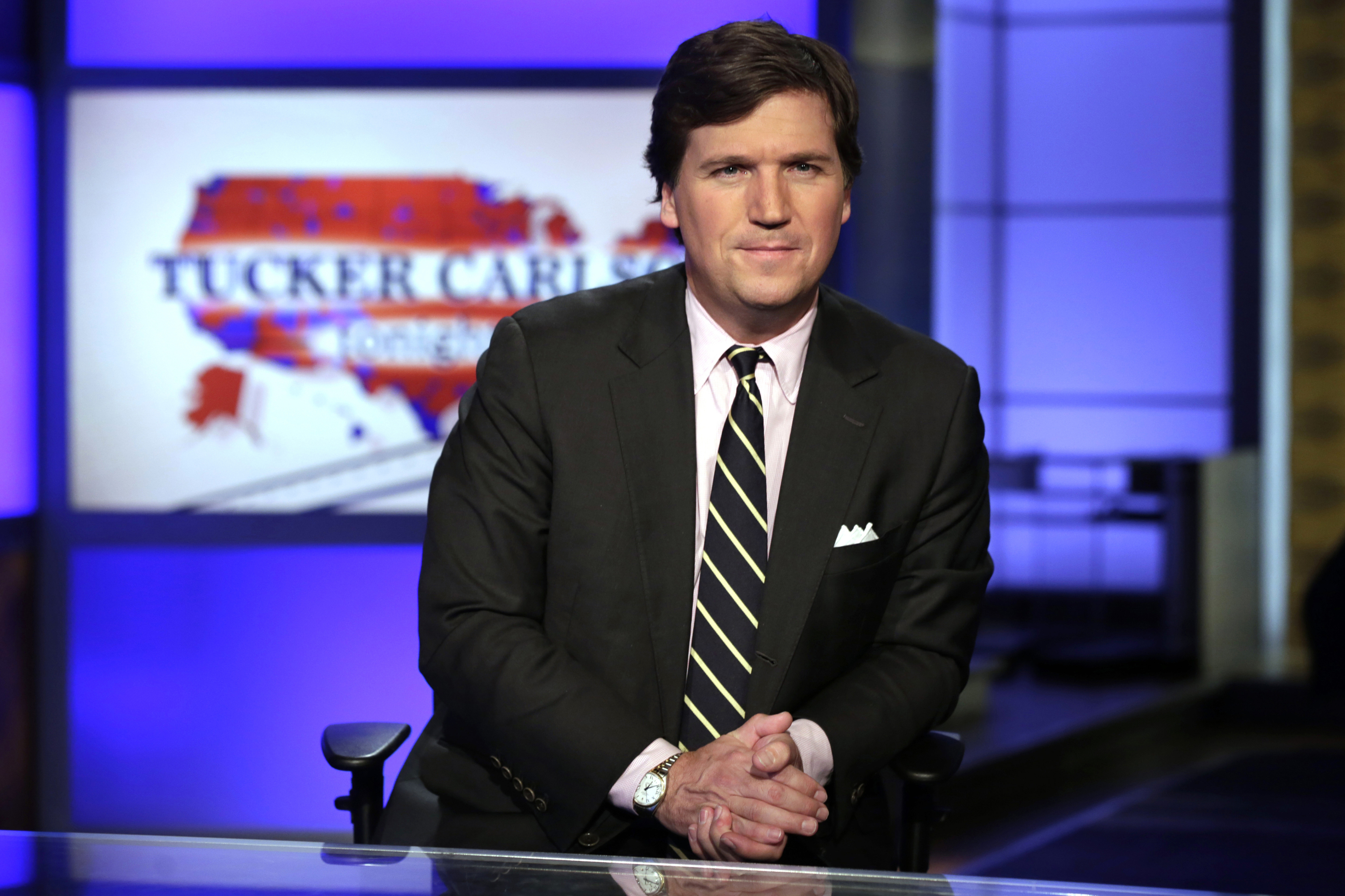 In this March 2, 2017 file photo, Tucker Carlson, host of ''Tucker Carlson Tonight,'' poses for photos in a Fox News Channel studio, in New York.