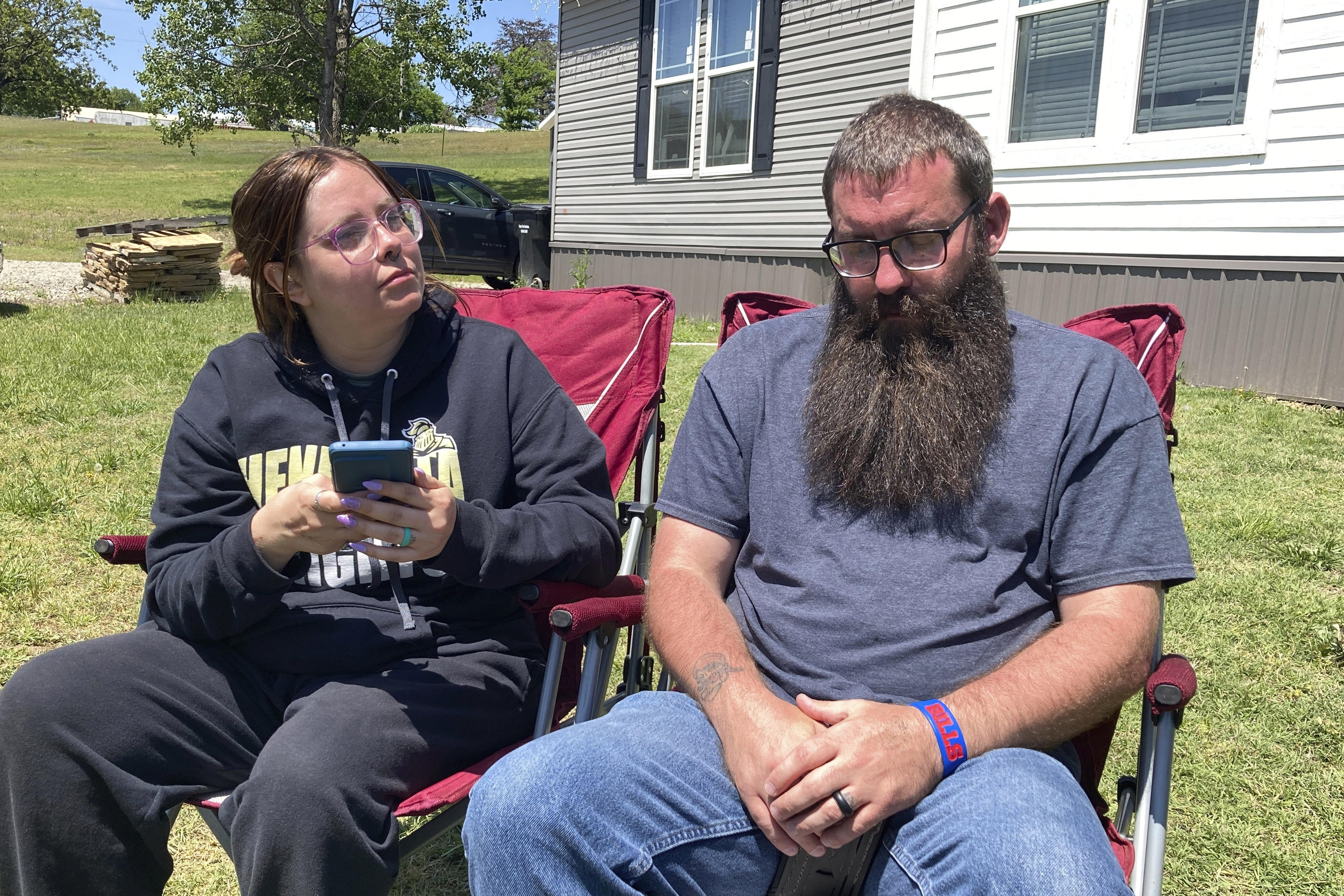  Justin Webster and his wife, Ashleigh, sit outside their Henryetta, Oklahoma, home on Tuesday, May 2, 2023. The couple's daughter, Ivy, 14, was among seven people found slain at a home in Henryetta on Monday.