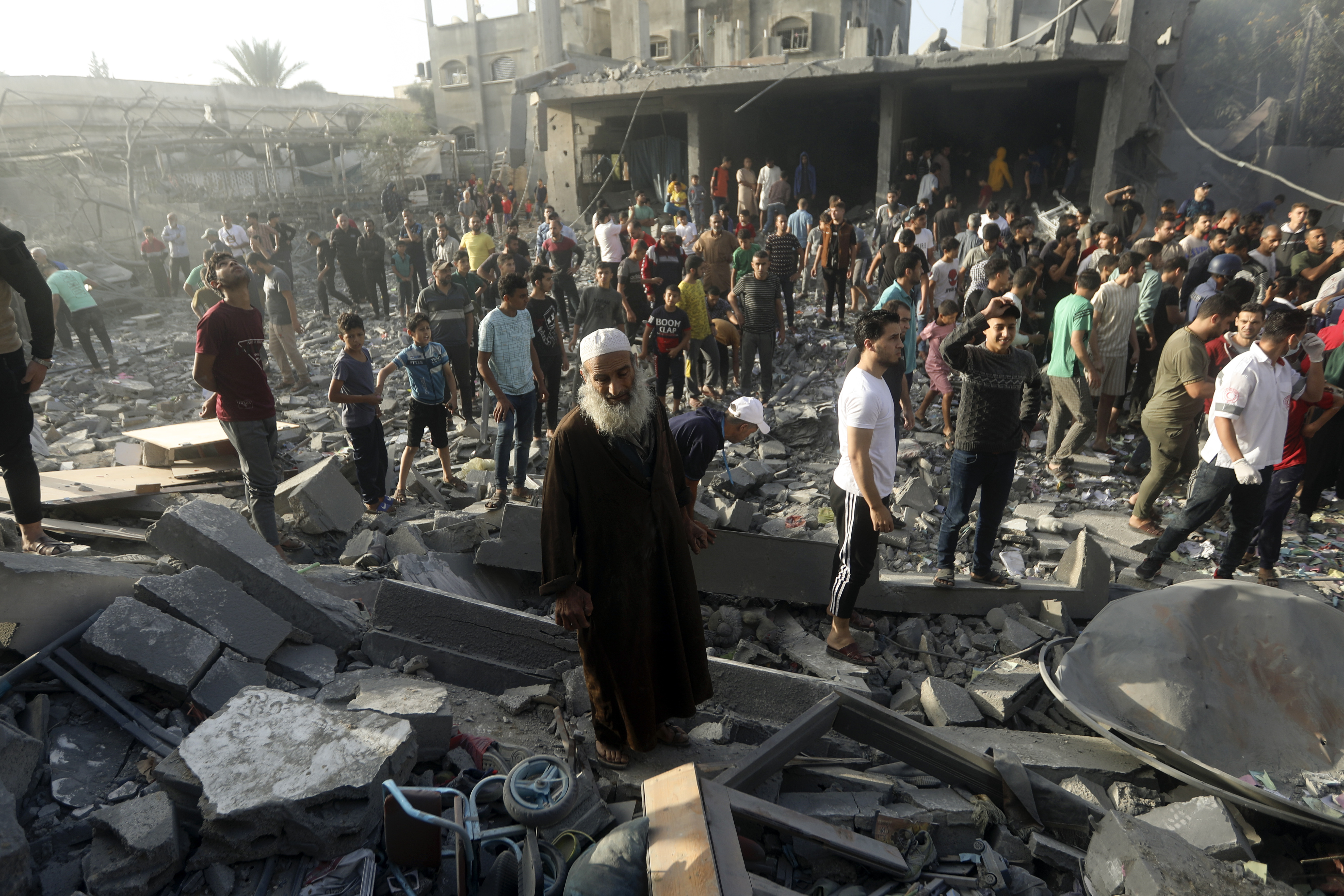 Palestinians look for survivors following an Israeli airstrike in Khan Younis refugee camp, southern Gaza Strip, Tuesday, Nov. 7, 2023.