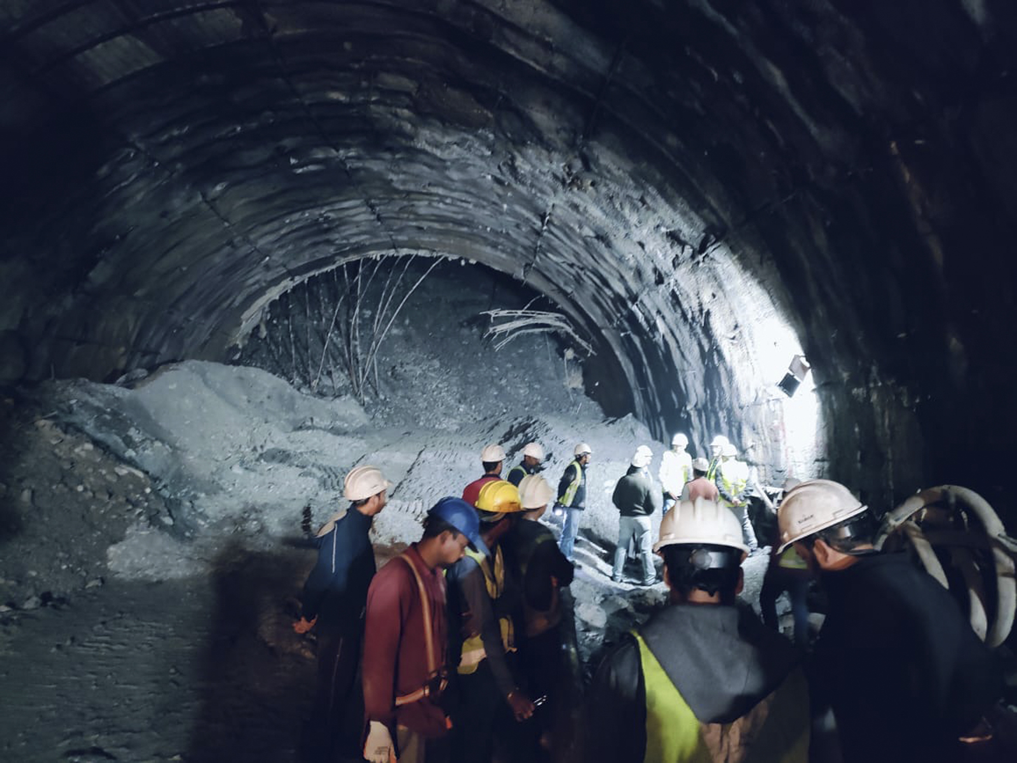 This photo provided by Uttarakhand State Disaster Response Force (SDRF) shows rescuers inside a collapsed road tunnel.