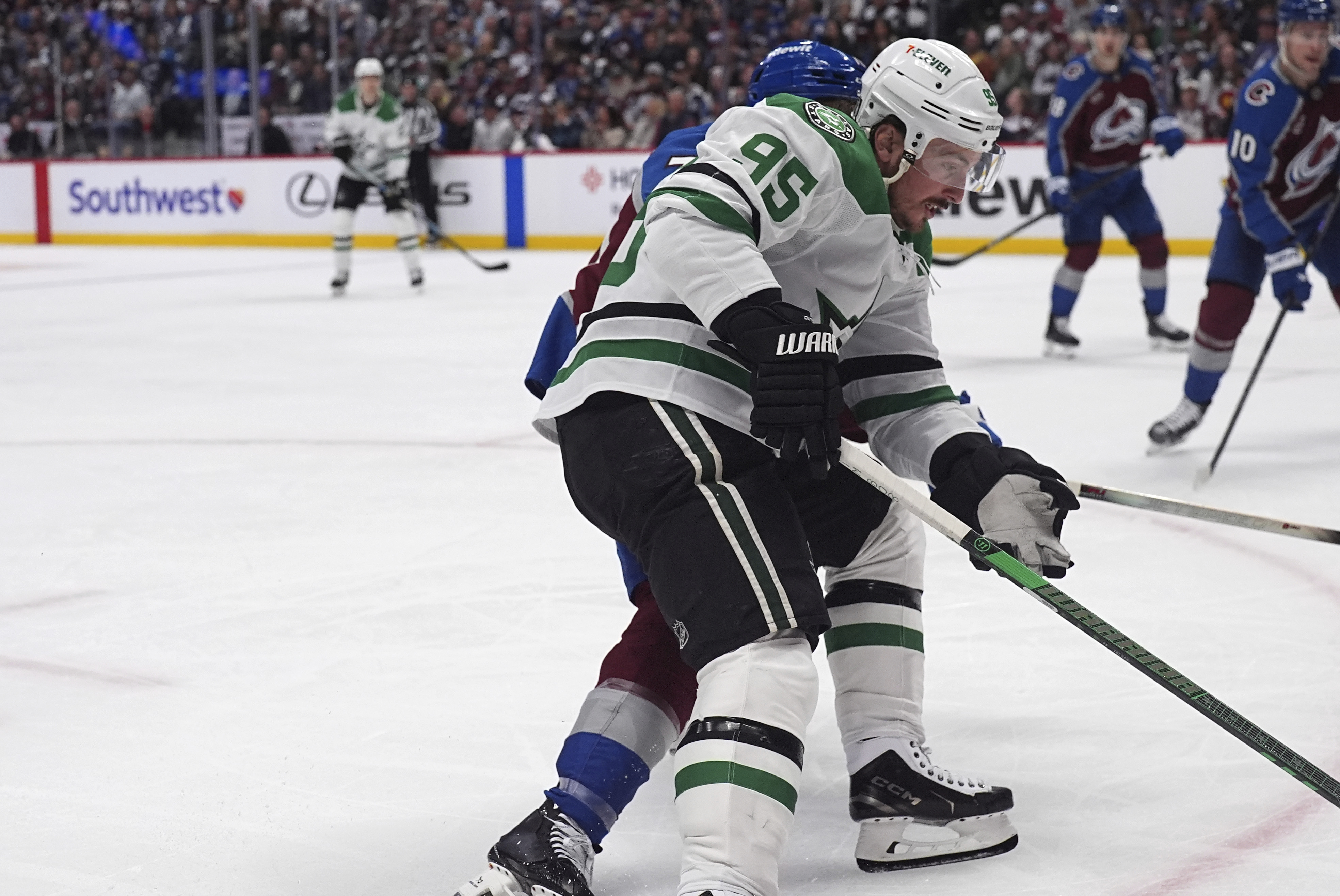 Dallas Stars center Matt Duchene, front, drives past Colorado Avalanche defenseman Sam Malinski in the second period of Game 3 of an NHL hockey first-round playoff series on Wednesday. (AP Photo/David Zalubowski).