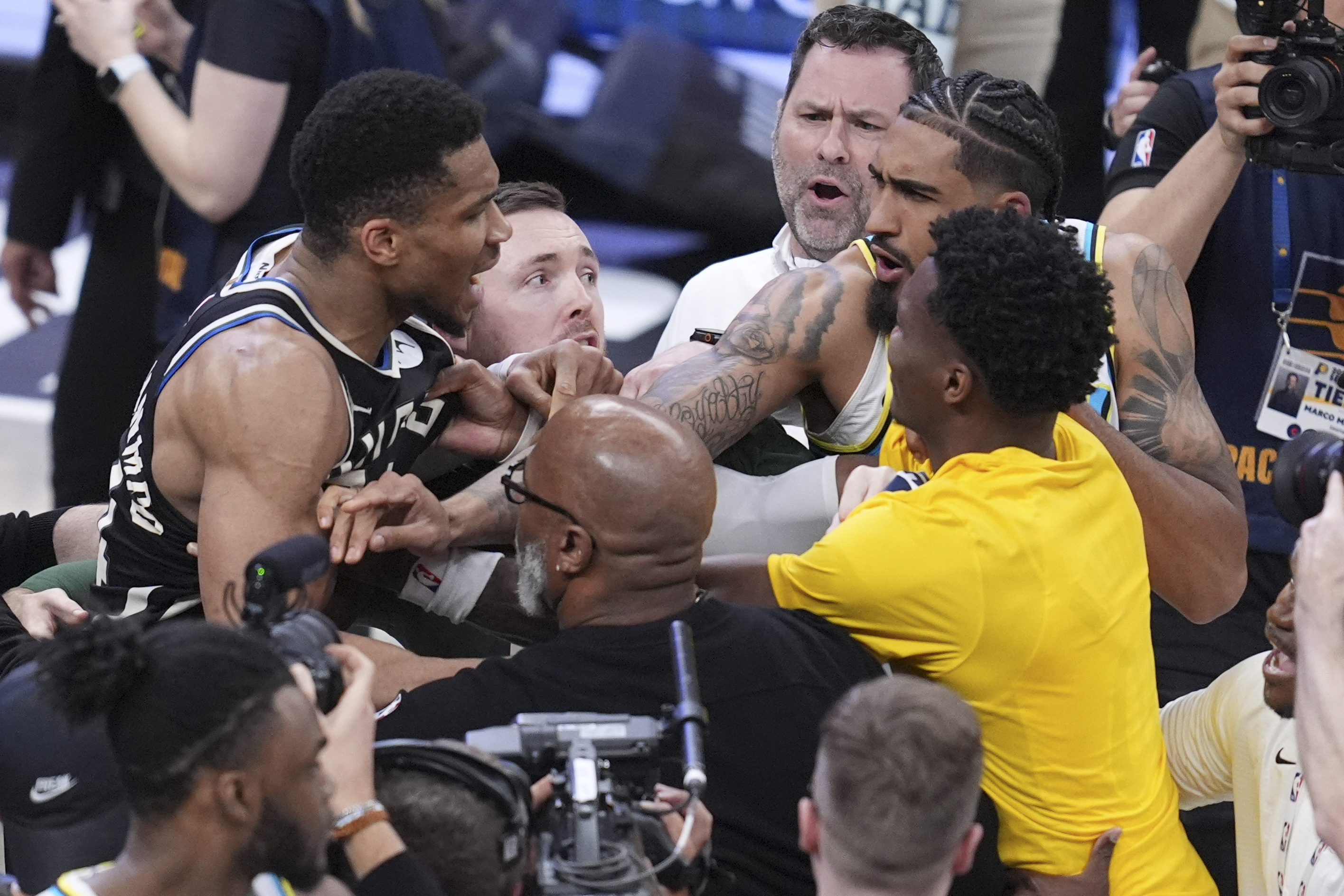 Milwaukee Bucks forward Giannis Antetokounmpo, left, is separated from Indiana Pacers players forward Obi Toppin, second from right, and guard Bennedict Mathurin, right, after Game 5 of an NBA basketball first-round playoff series in Indianapolis on Tuesday. (AP Photo/Michael Conroy).