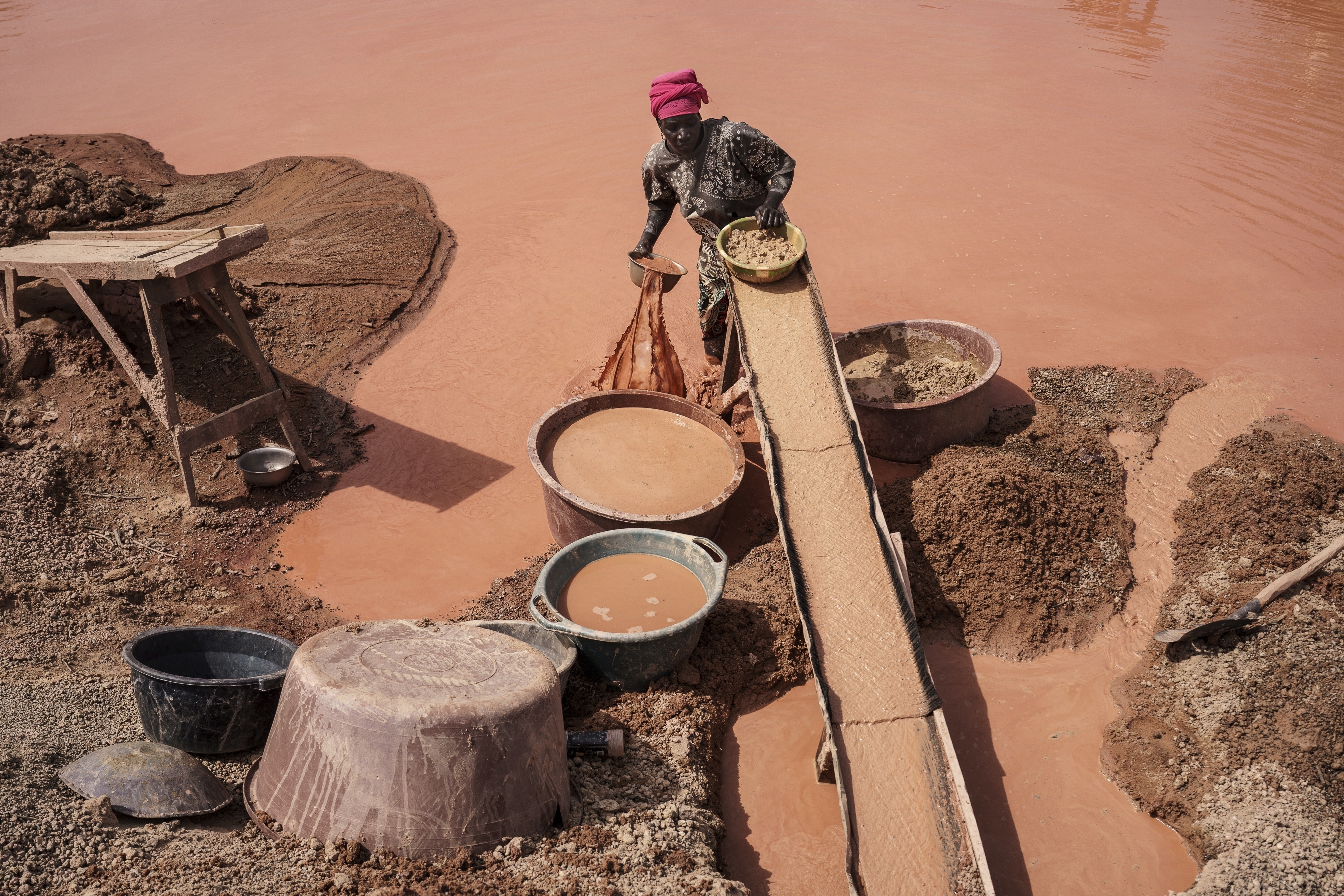 A woman processes gold at a mining site in the Kedougou region of Senegal in January. (AP Photo/Annika Hammerschlag).