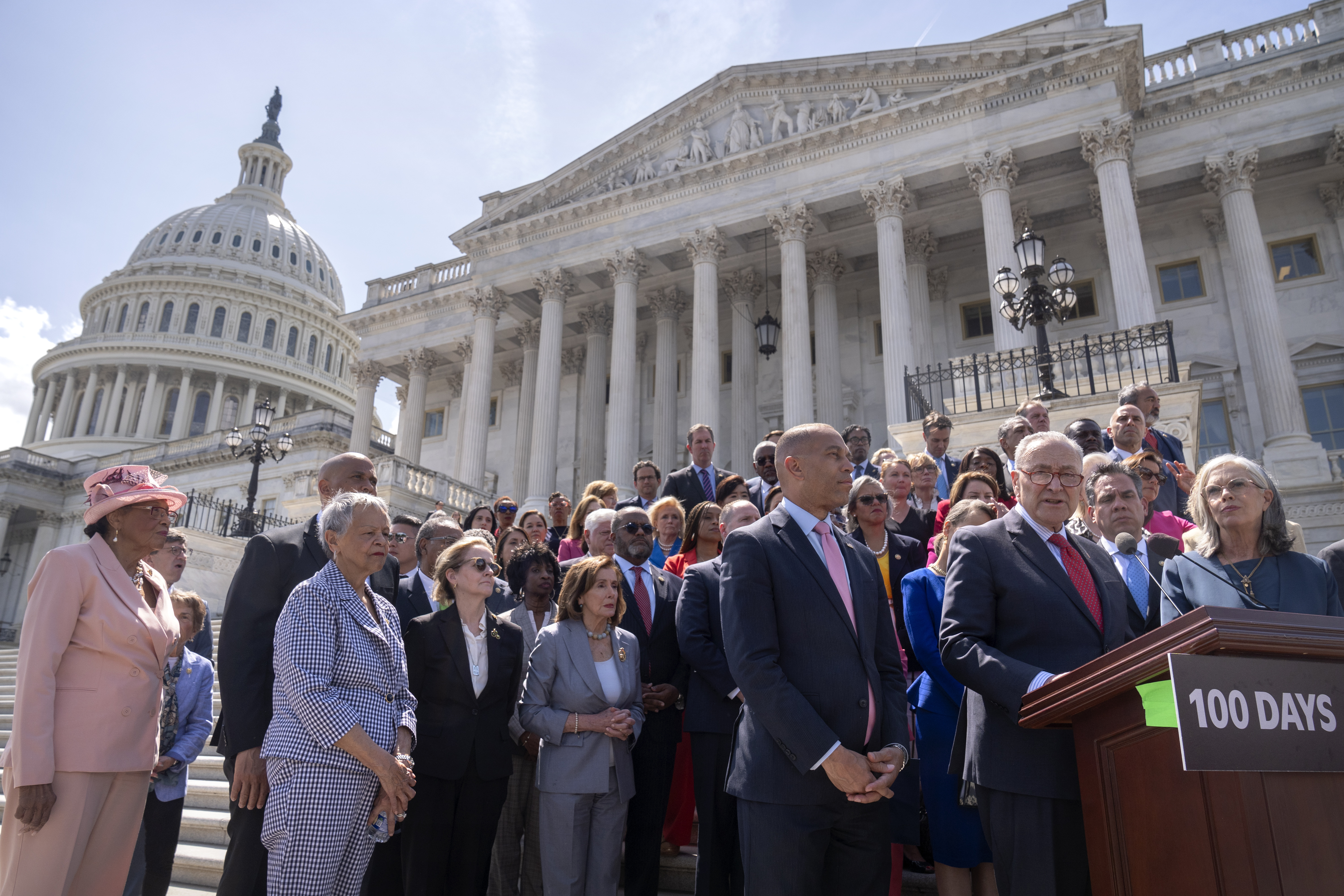 Senate Minority Leader Chuck Schumer, right, is flanked by House Minority Leader Hakeem Jeffries, as he speaks during an event with House and Senate Democrats to mark 100 days of President Donald Trump's term on the steps of the Senate on Capitol Hill on April 30 in Washington. (AP Photo/Mark Schiefelbein).