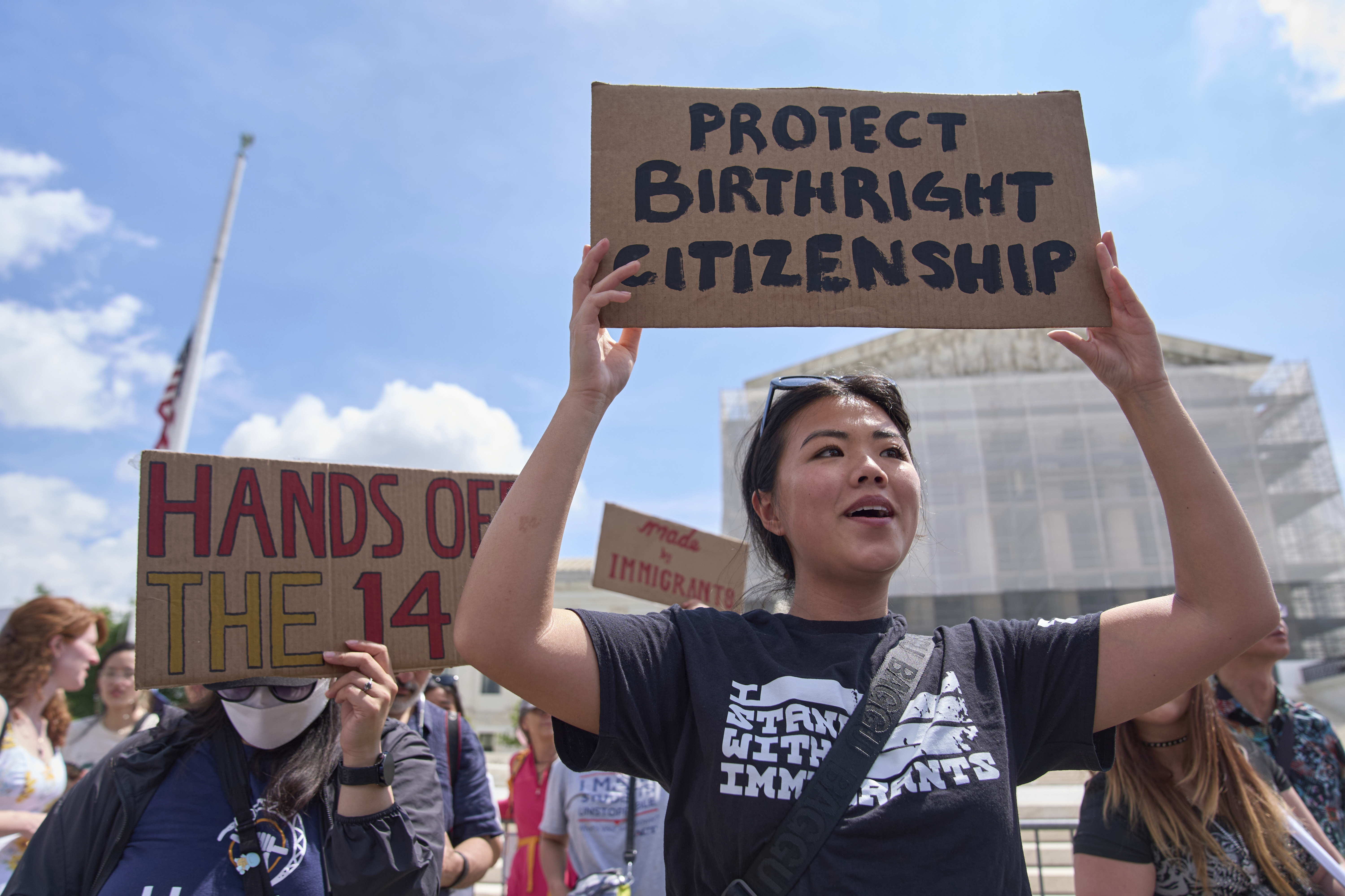 Hannah Liu, 26, of Washington, holds up a sign in support of birthright citizenship Thursday outside of the Supreme Court in Washington. ''This is enshrined in the Constitution. My parents are Chinese immigrants,'' says Liu. ''They came here on temporary visas so I derive my citizenship through birthright.'' (AP Photo/Jacquelyn Martin).