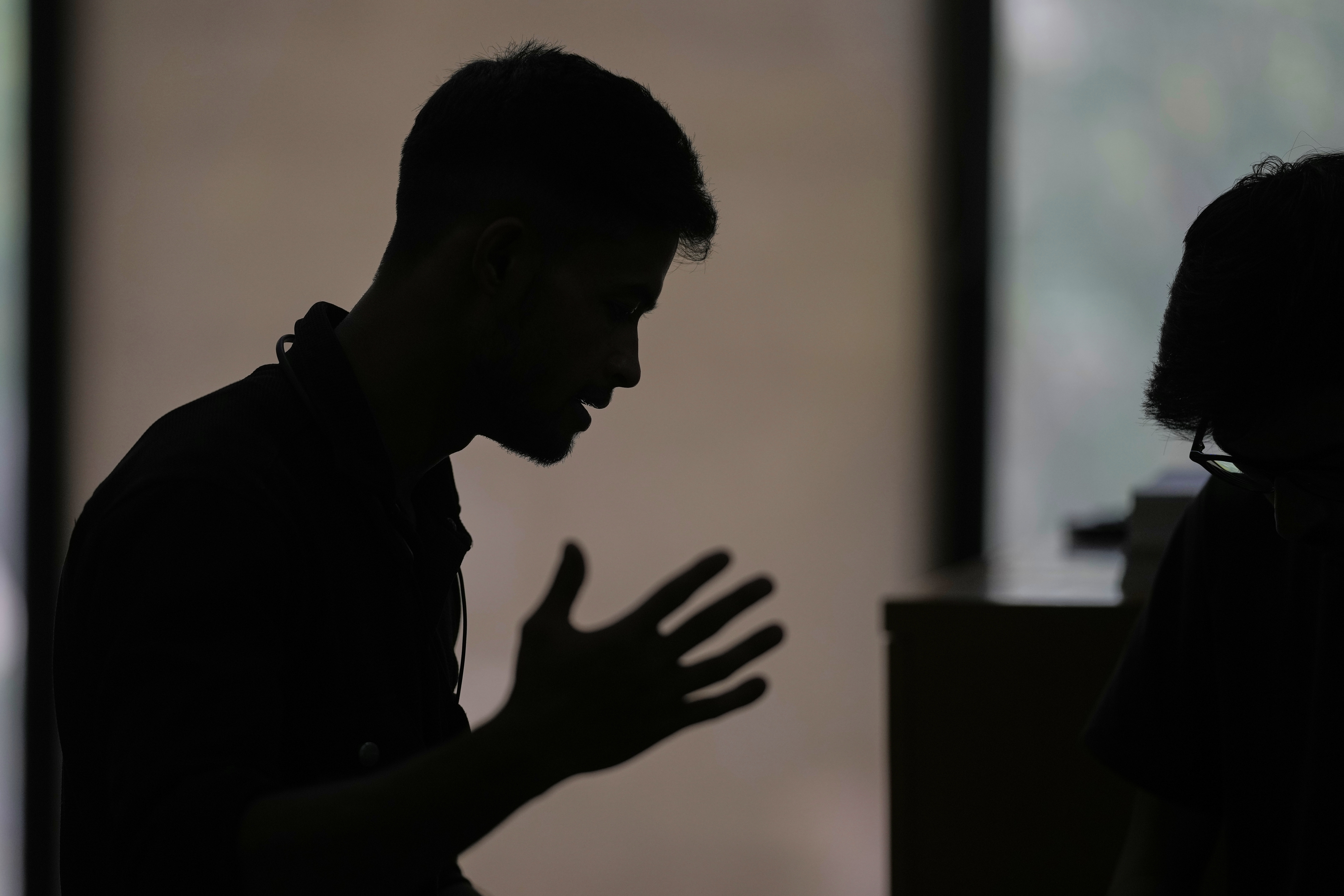 A Rohingya refugee who has not been identified due to safety concerns, talks to The Associated Press in New Delhi, India, about how his family was deported to an island in Myanmar, Friday. (AP Photo/Manish Swarup).