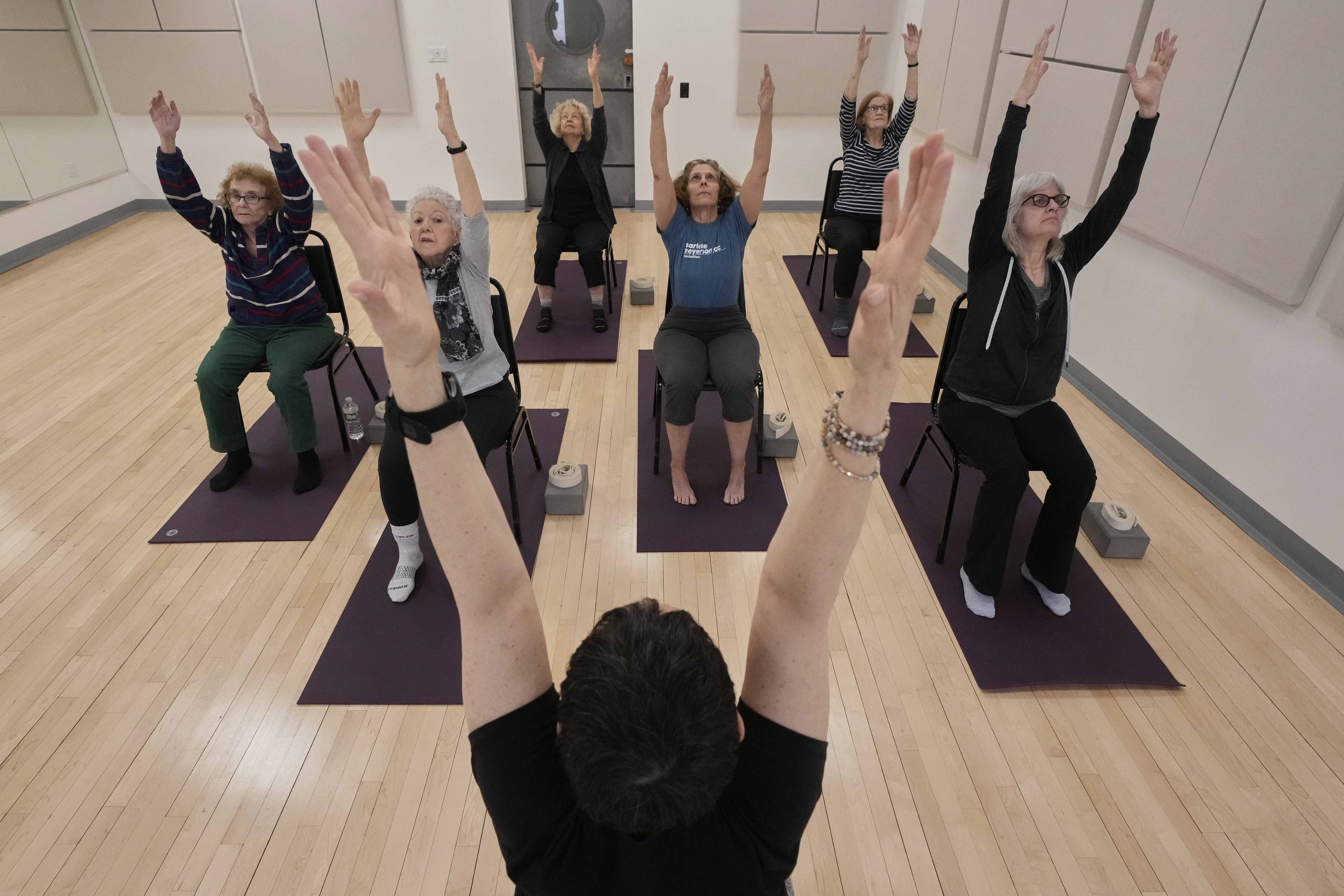 Whitney Chapman, foreground center, conducts a chair yoga class at the Marlene Meyerson JCC Manhattan, in New York in March. (AP Photo/Richard Drew).