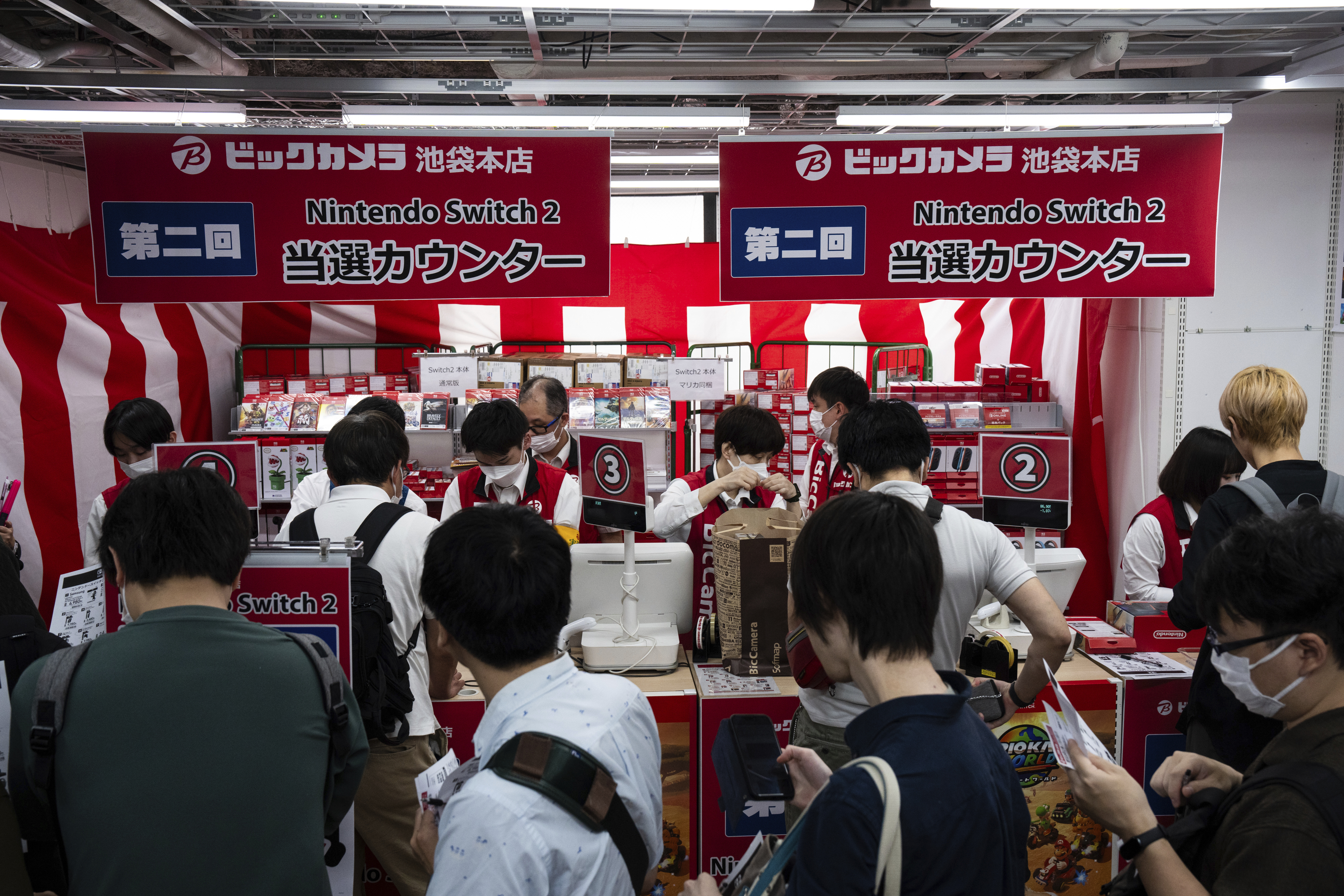 Customers line up to purchase Nintendo Switch 2 at an electronics retailer in Tokyo on Thursday. (AP Photo/Louise Delmotte).