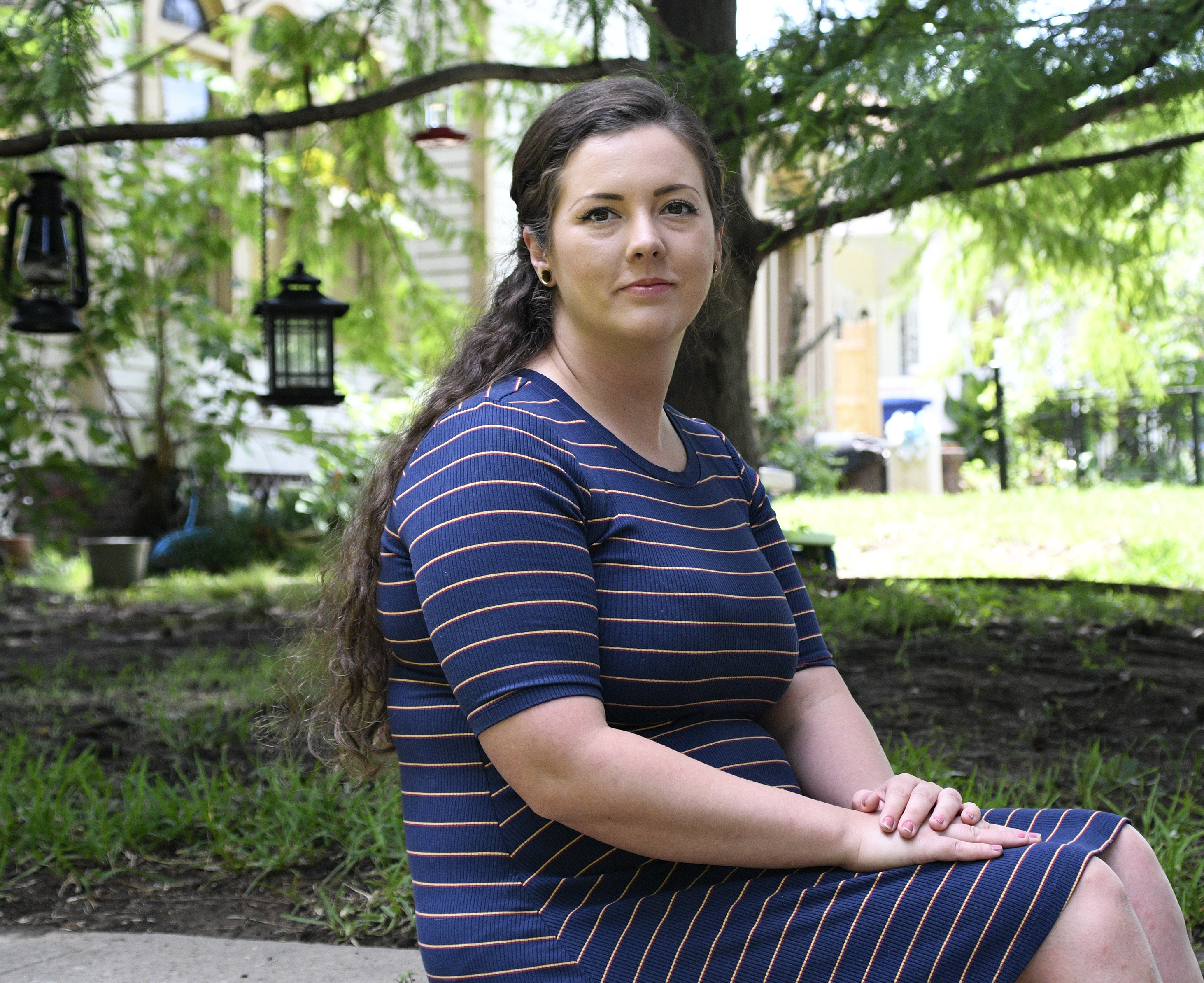 Brittnee Nelson, who runs her own housecleaning business, poses for a portrait in her neighborhood in Shreveport, La. on Monday. (AP Photo/Jill Pickett).