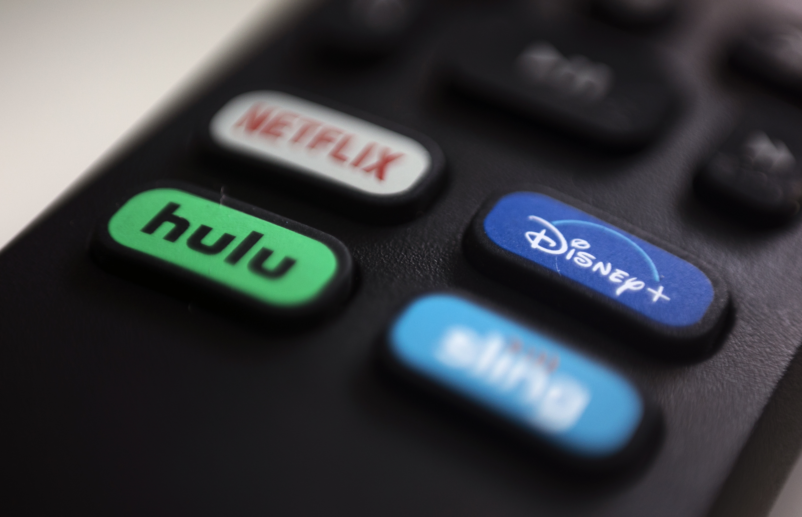 The logos for streaming services Netflix, Hulu, Disney Plus and Sling TV are pictured on a remote control in 2020. (AP Photo/Jenny Kane, File).