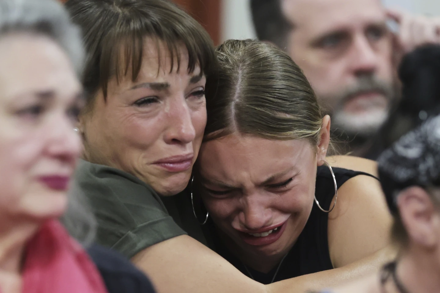 Dylan Mortensen gets a hug after speaking at the sentencing hearing of Bryan Kohberger at the Ada County Courthouse, for his sentencing hearing on Wednesday in Boise, Idaho. (AP Photo/Kyle Green, Pool)