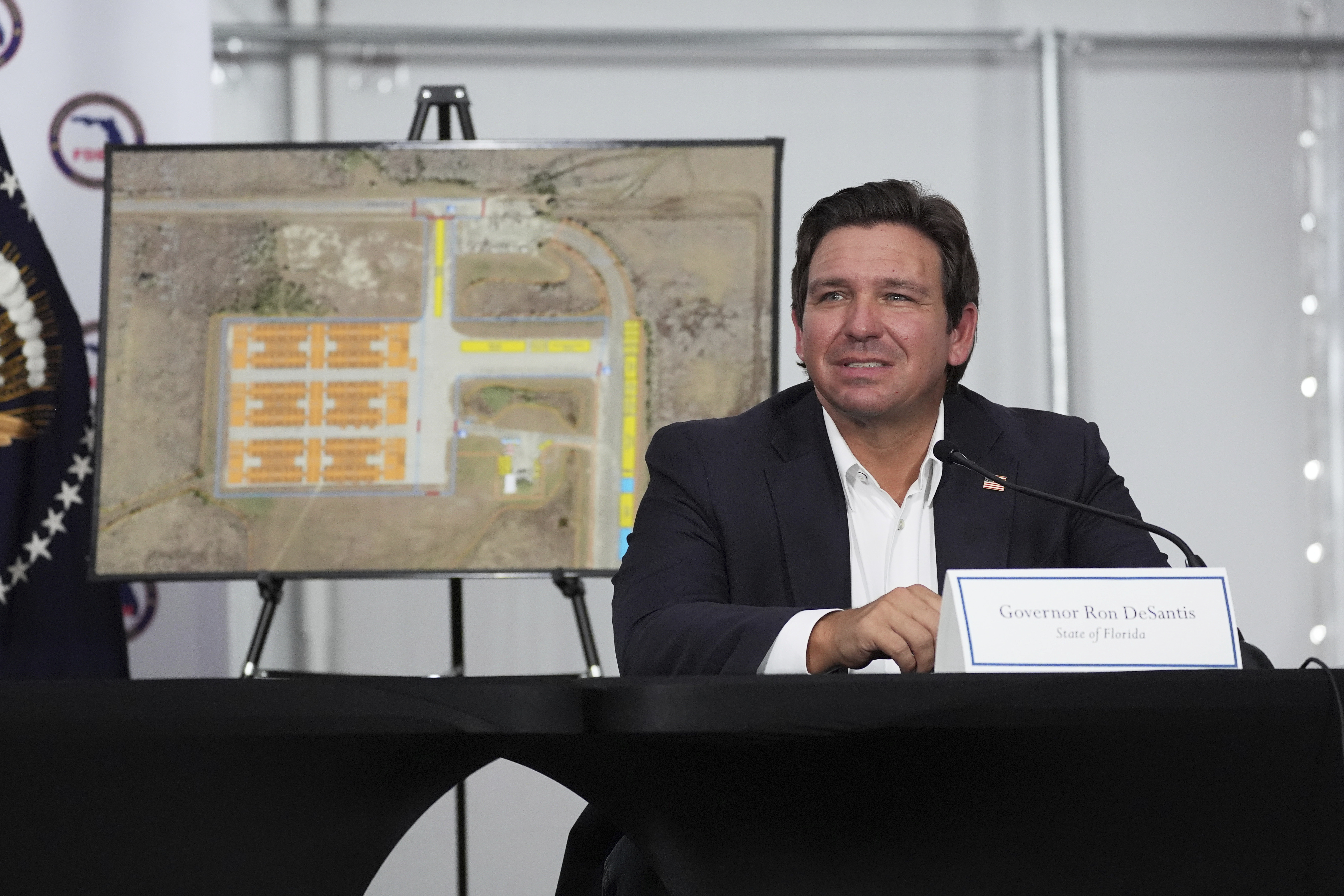 Gov. Ron DeSantis, R-Fla., listens during a roundtable at Alligator Alcatraz, a new migrant detention facility at Dade-Collier Training and Transition facility, July 1, in Ochopee, Fla. (AP Photo/Evan Vucci).