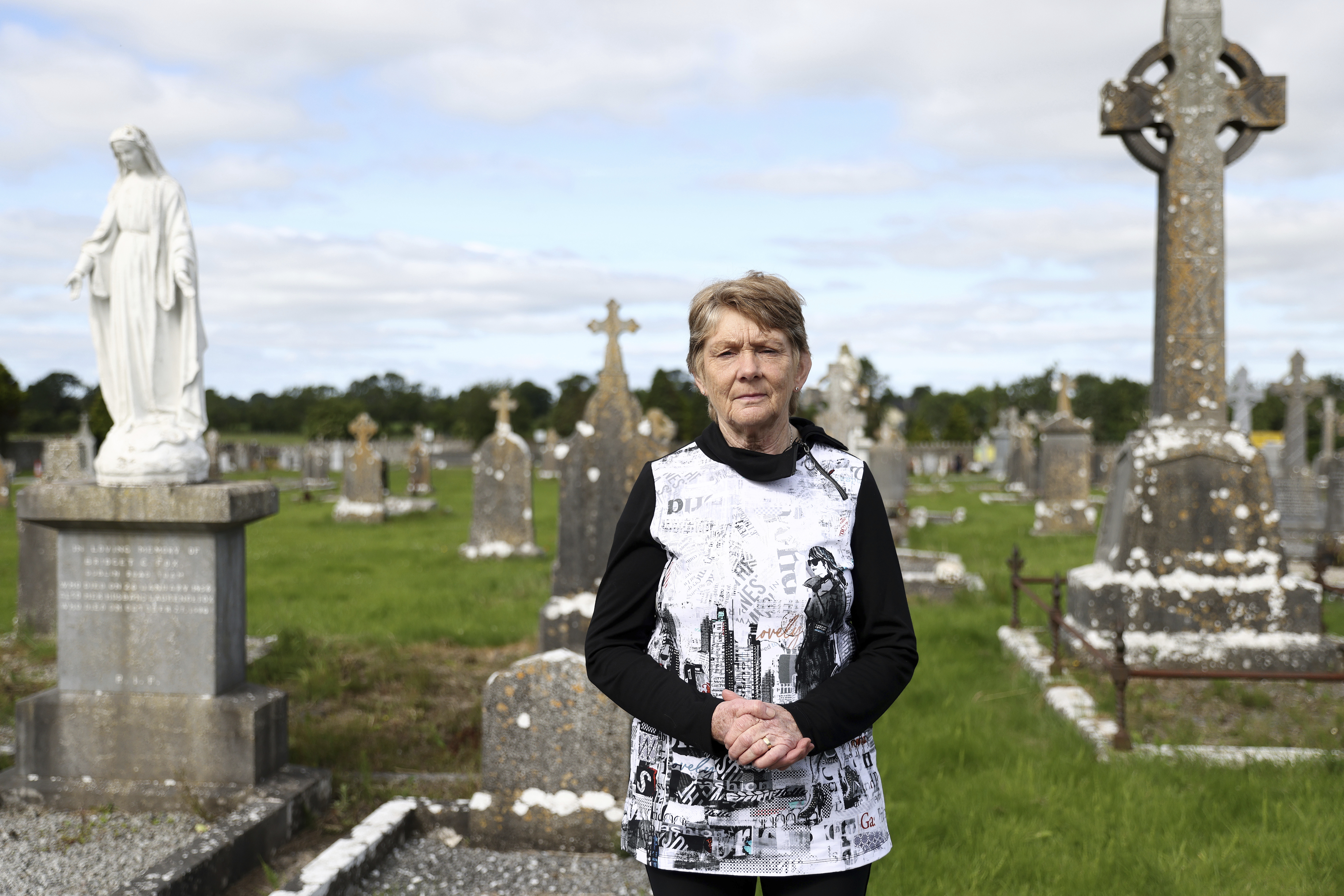 Historian Catherine Corless poses for a photo at Tuam cemetery, Ireland, in Tuam, Ireland, July 7, 2025. (AP Photo/Peter Morrison)