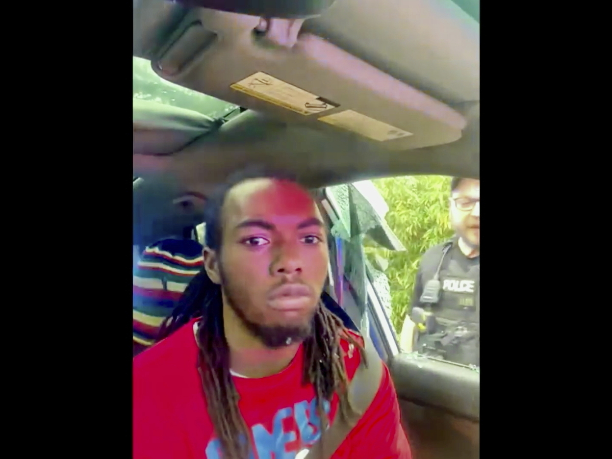 In this image made from cell phone video provided by the Law Office of Harry M. Daniels via TMX, William McNeil Jr. is seen sitting in his car after an officer broke his car window during a traffic stop on Feb. 19, 2025, in Jacksonville, Fla. (The Law Office of Harry M. Daniels/TMX via AP)