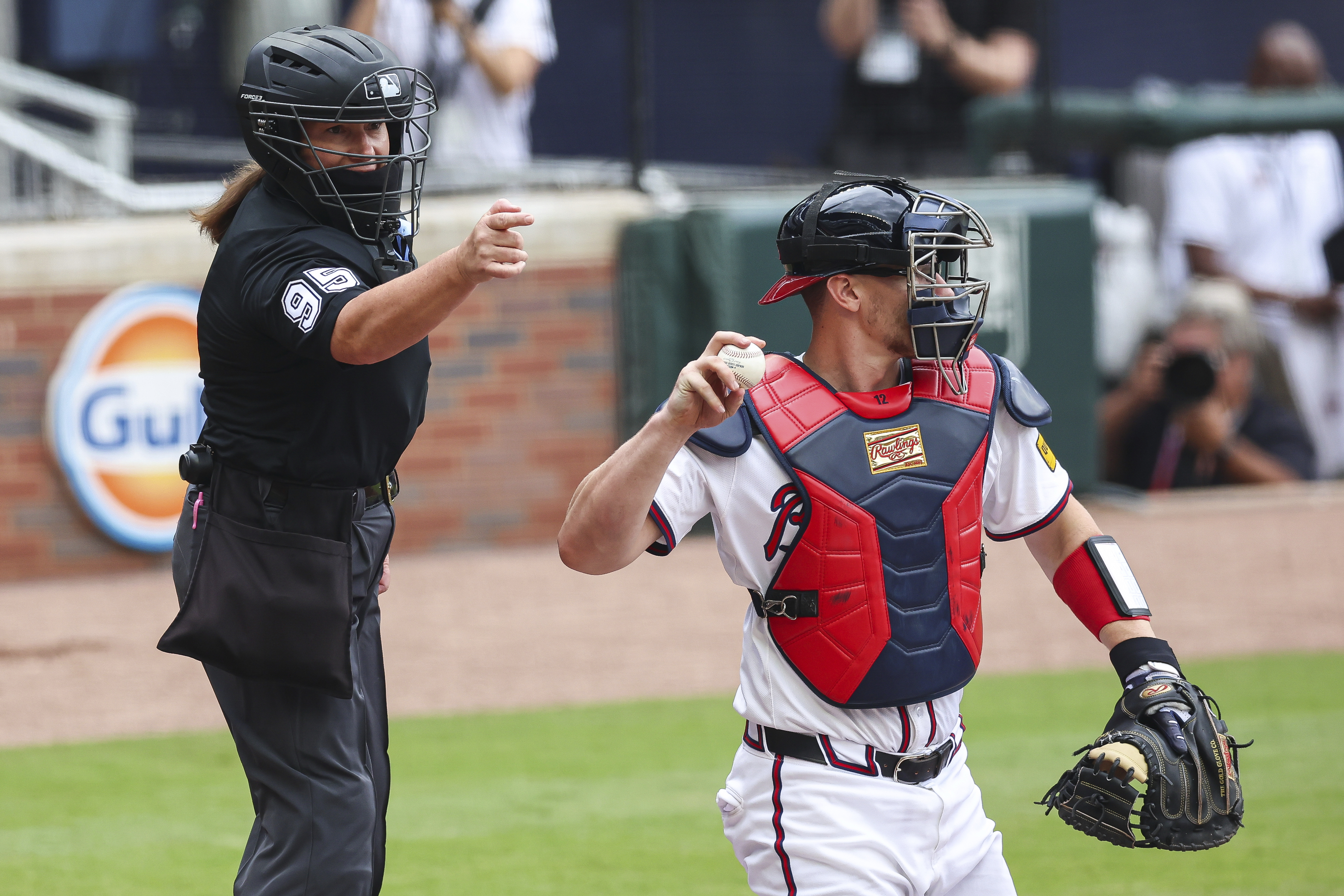 Home plate umpire Jen Pawol calls a strike during the first inning of a baseball game between the Miami Marlins and Atlanta Braves, Sunday in Atlanta. (AP Photo/Colin Hubbard)