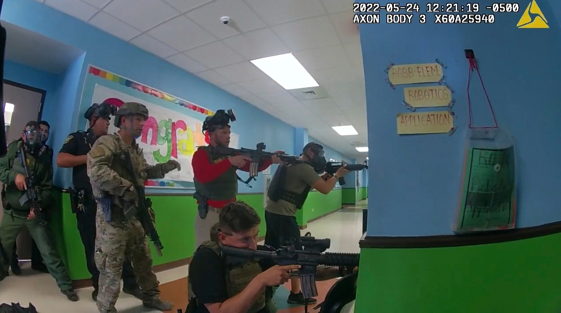 In this image from police body cam video provided by the Uvalde County Sheriff's Department, law enforcement agents ready their weapons during the shooting at Robb Elementary School in Uvalde, Texas, on May 24, 2022. (Uvalde County Sheriff's Department via AP)
