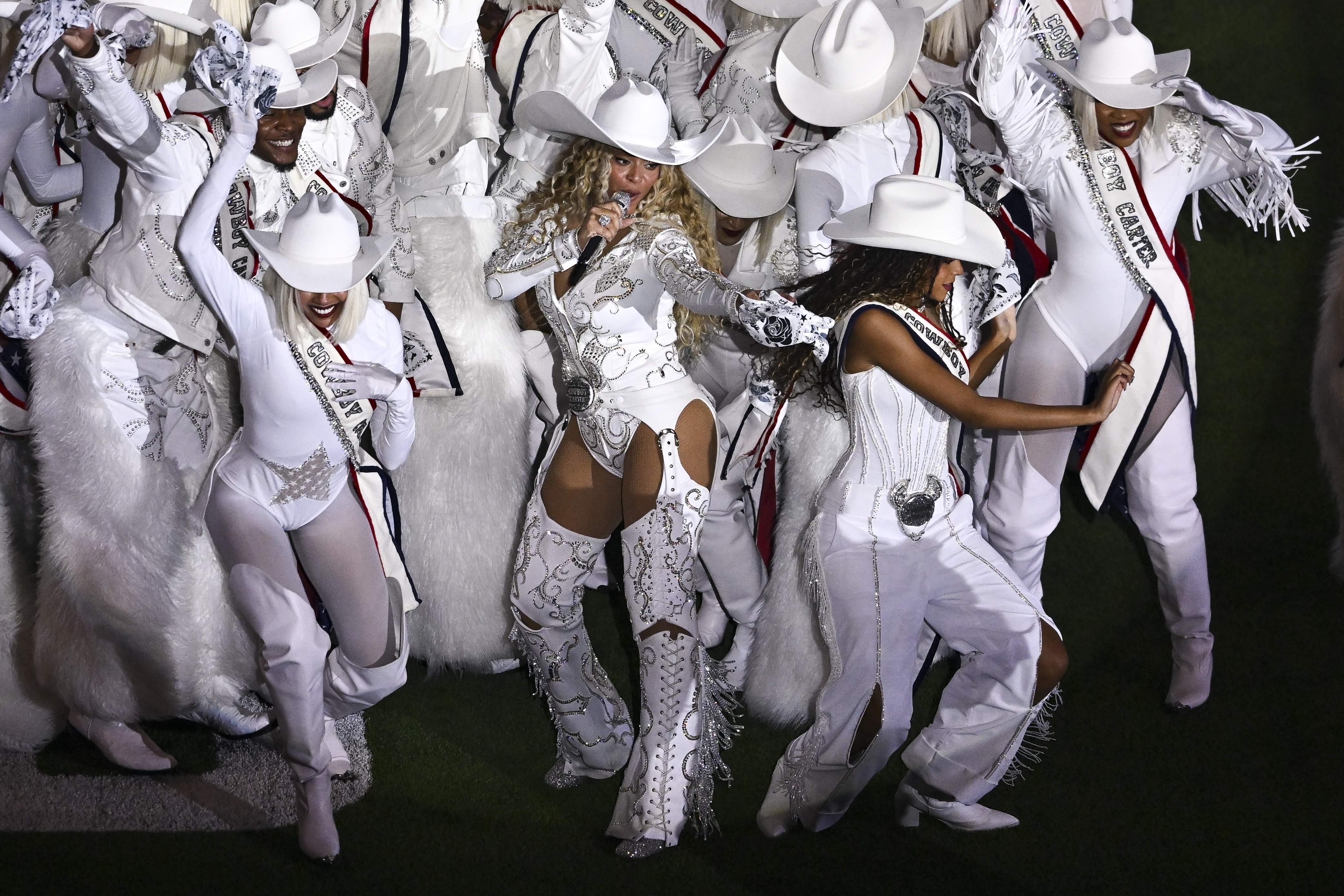 Beyoncé, center, is joined by her daughter Blue Ivy, right, during a halftime performance in an NFL football game between the Baltimore Ravens and the Houston Texans, Dec. 25, 2024, in Houston. (AP Photo/Maria Lysaker, File)