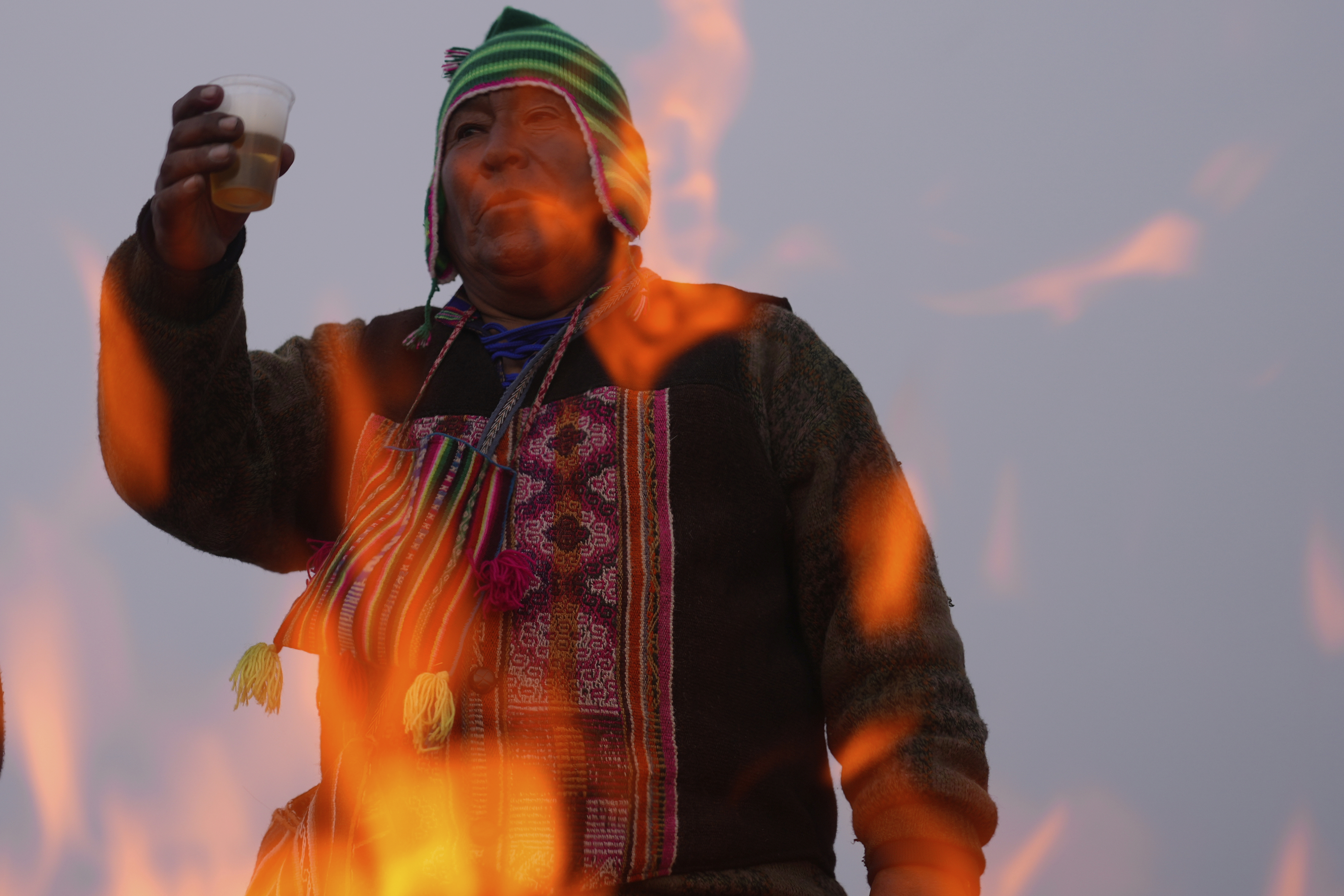 Spiritual leader Eusebio Huanca burns offerings observing the month of Pachamama, or Mother Earth, performing an ancient tradition to ask for a good harvest, on La Cumbre, a mountain considered sacred on the outskirts of La Paz, Bolivia, Friday, Aug. 1, 2025. (AP Photo/Juan Karita)