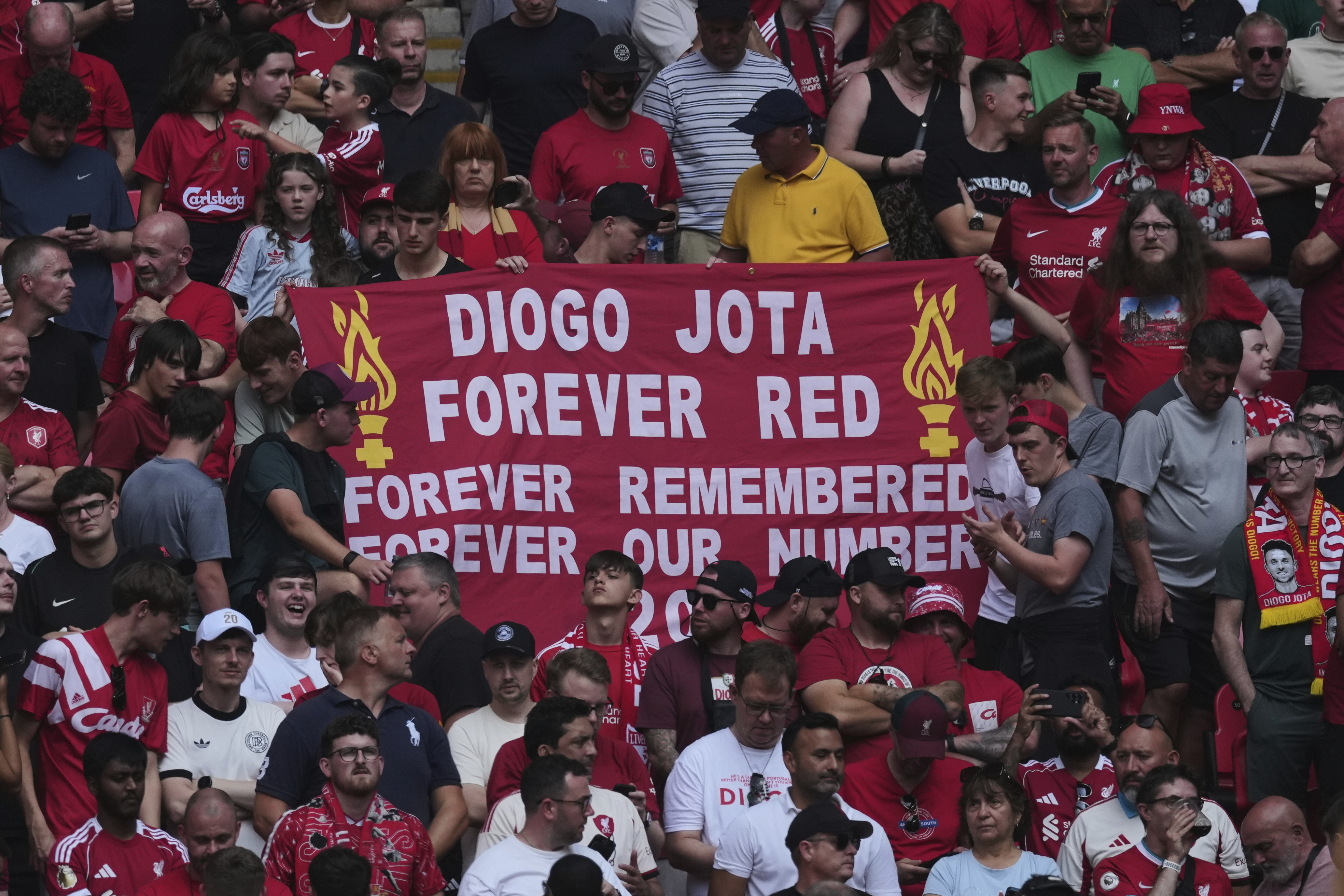 Liverpool fans hold a banner in the memory of Diogo Jota before the FA Community Shield final soccer match between Liverpool and Crystal Palace at Wembley Stadium in London on Sunday. (AP Photo/Dave Shopland).