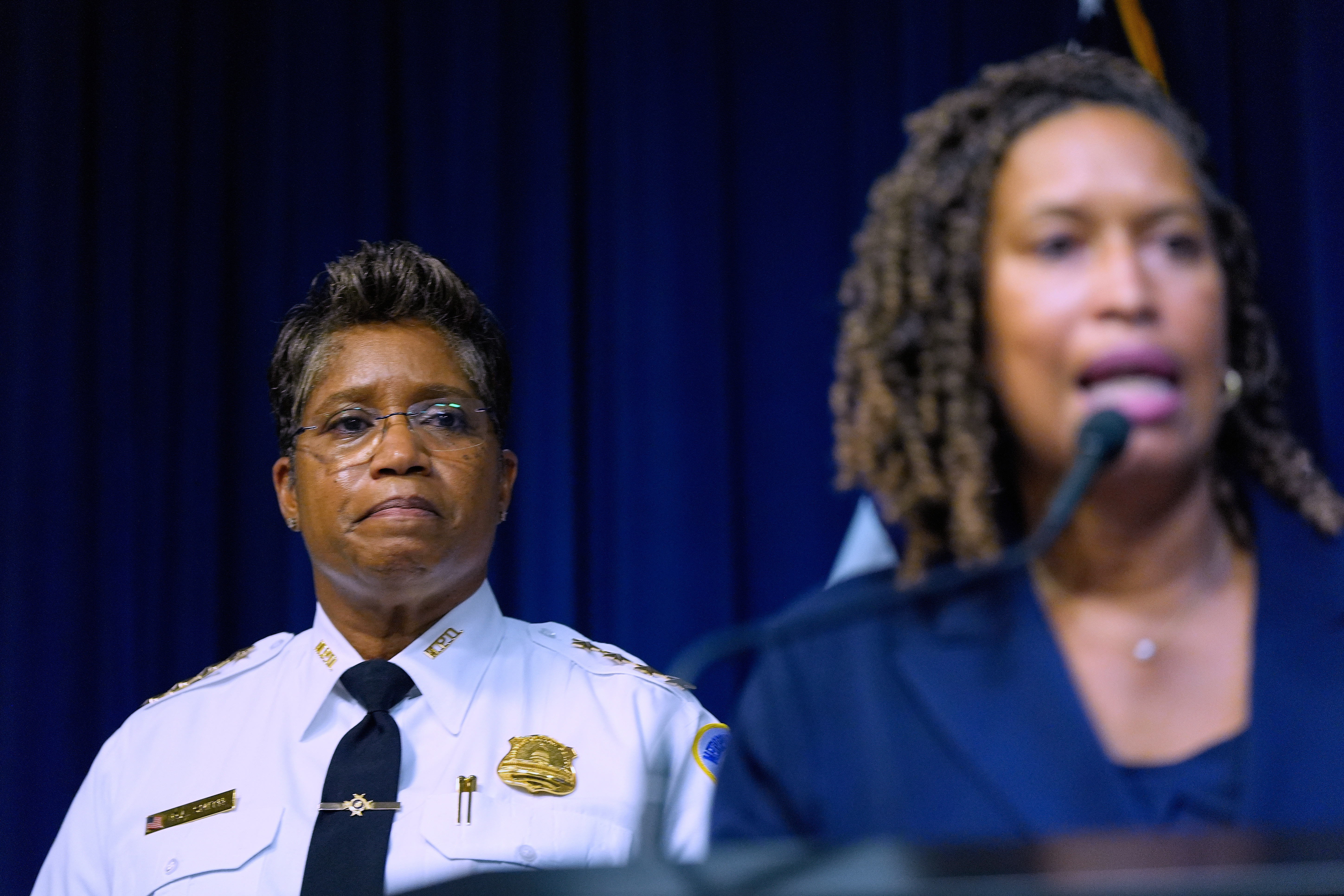 Metropolitan Police Department Chief Pamela Smith listens Monday as Washington Mayor Muriel Bowser speak during a news conference in Washington. (AP Photo/Julia Demaree Nikhinson).