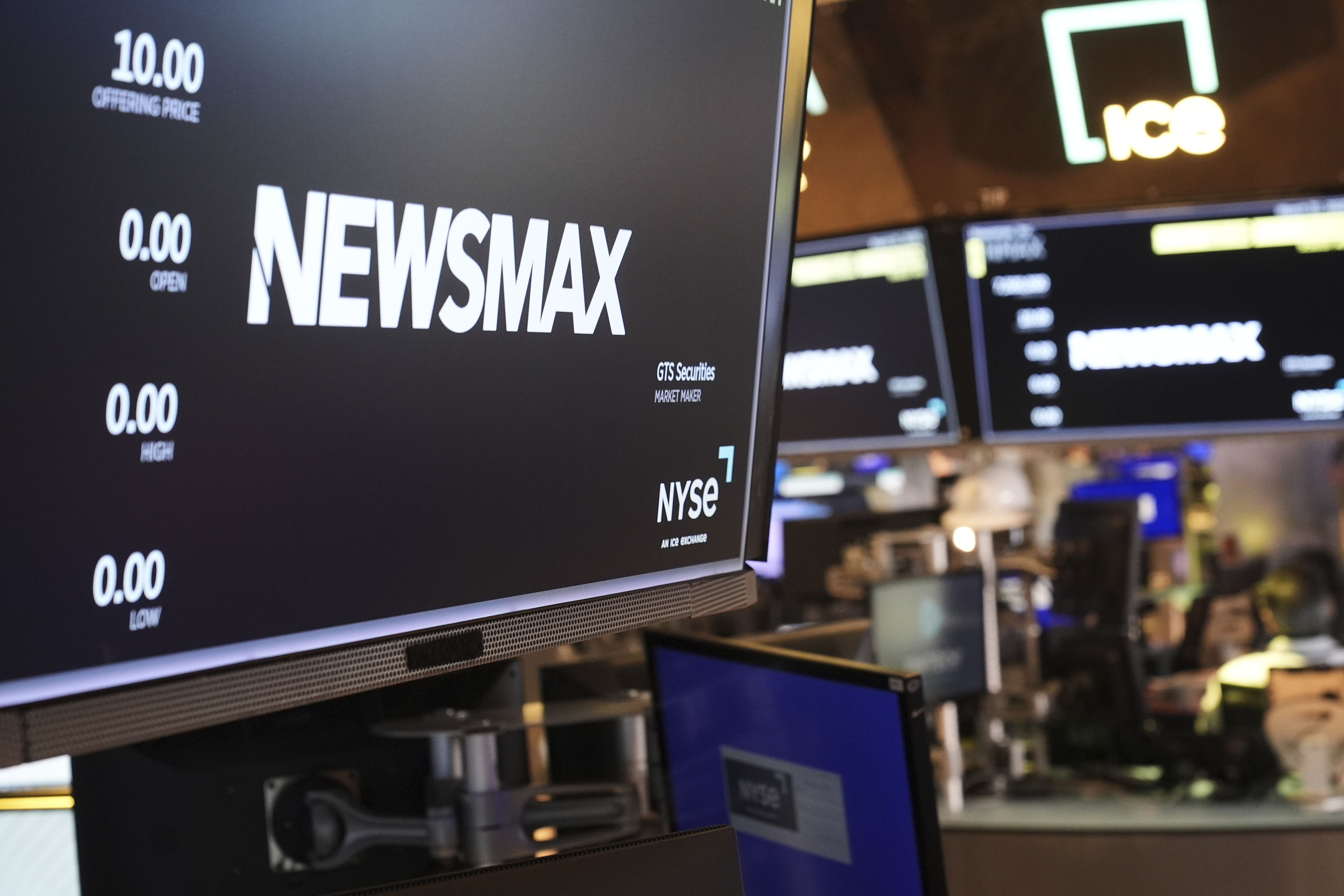 A display shows a Newsmax logo on the day of their IPO on the floor at the New York Stock Exchange in New York, March 31, 2025. (AP Photo/Seth Wenig, File)