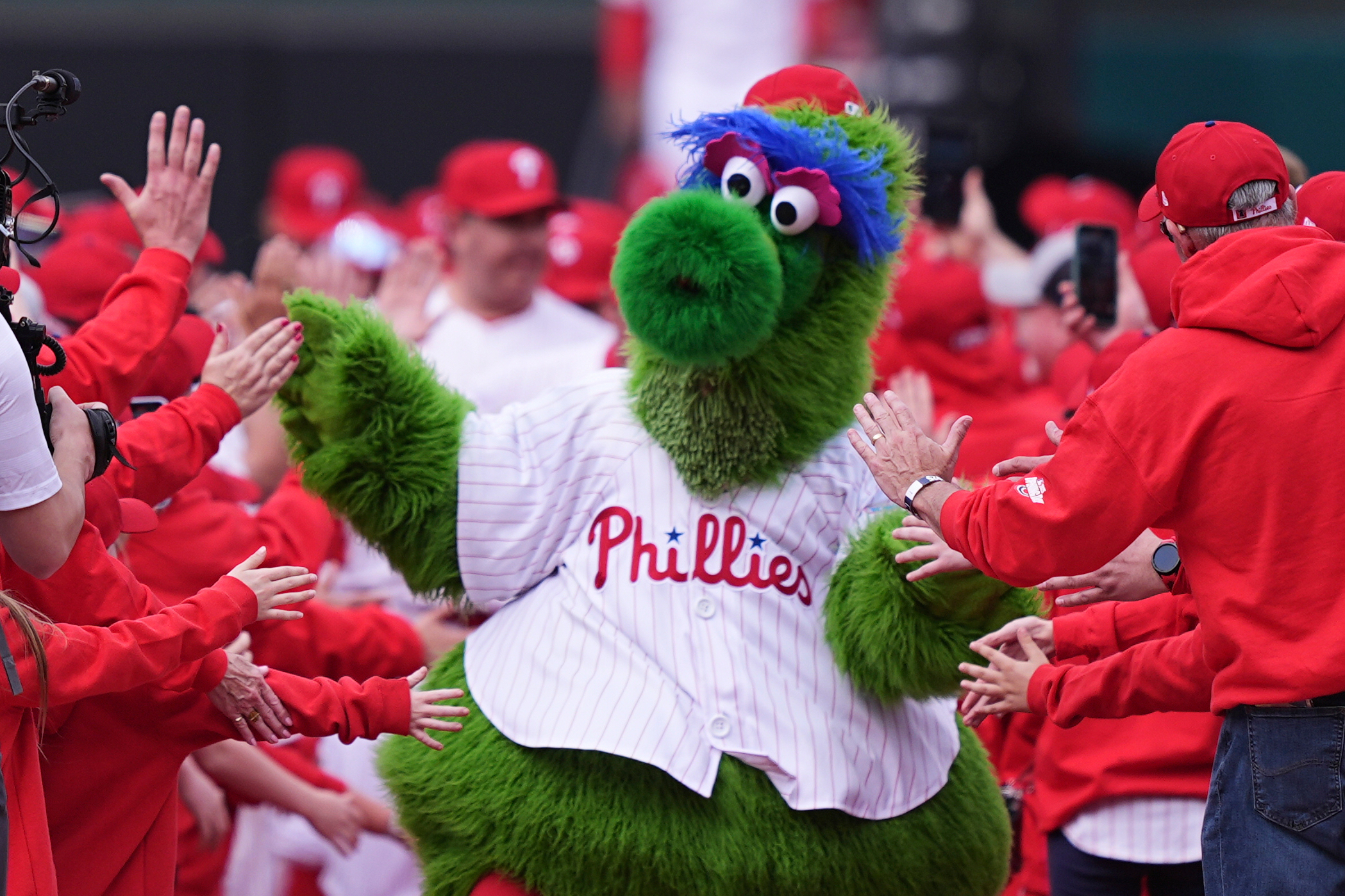 The Phillie Phanatic, the Philadelphia Phillies mascot, leads the team onto the field ahead for their home-opener baseball game against the Colorado Rockies, Monday, March 31, 2025, in Philadelphia. (AP Photo/Matt Rourke, File)