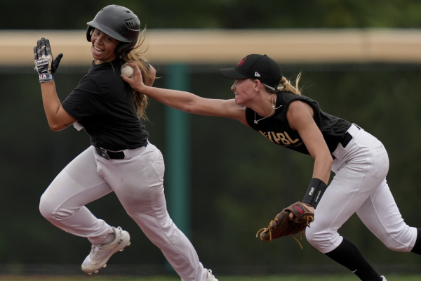 Meagan Haney, right, tags out another player 