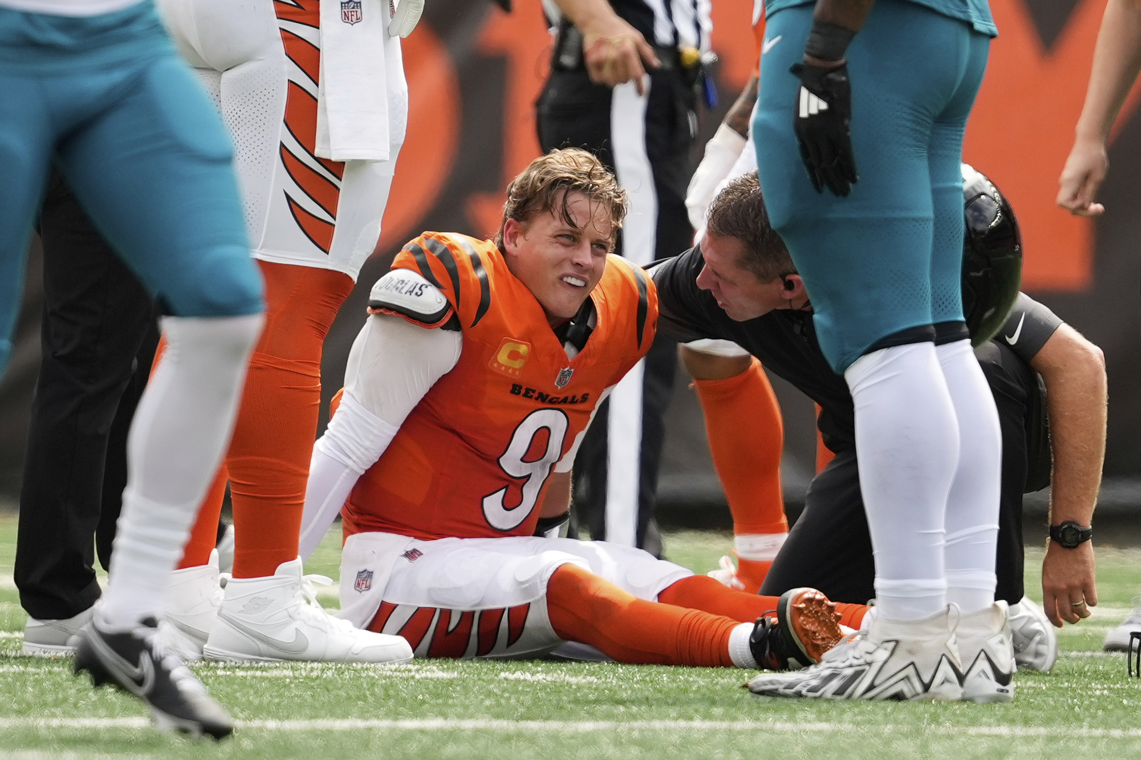 Cincinnati Bengals quarterback Joe Burrow (9) grimaces aft being sacked by Jacksonville Jaguars defensive tackle Arik Armstead (91) during the first half of an NFL football game on Sunday. (AP Photo/Carolyn Kaster).