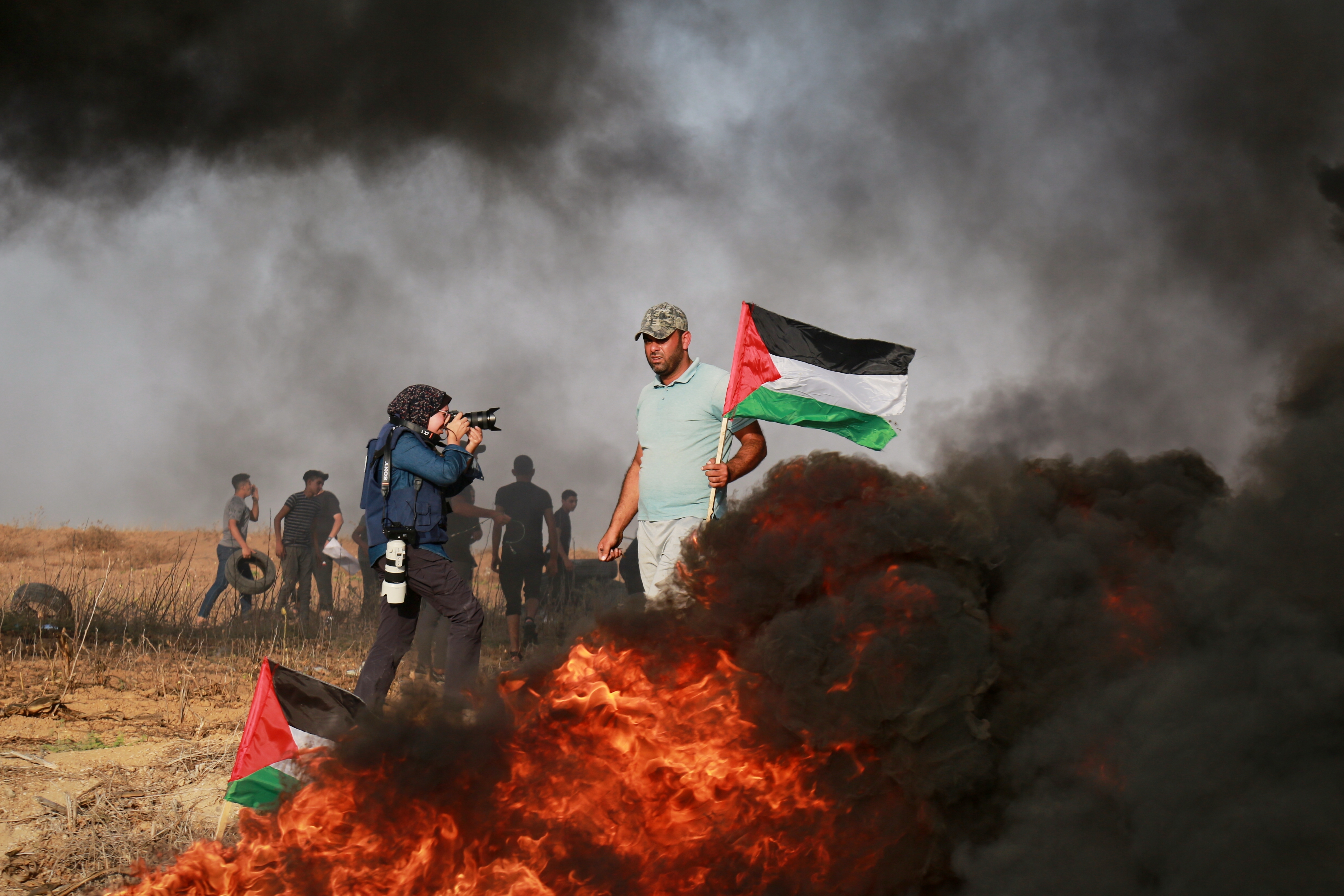 People run for cover during an Israeli airstrike in Gaza