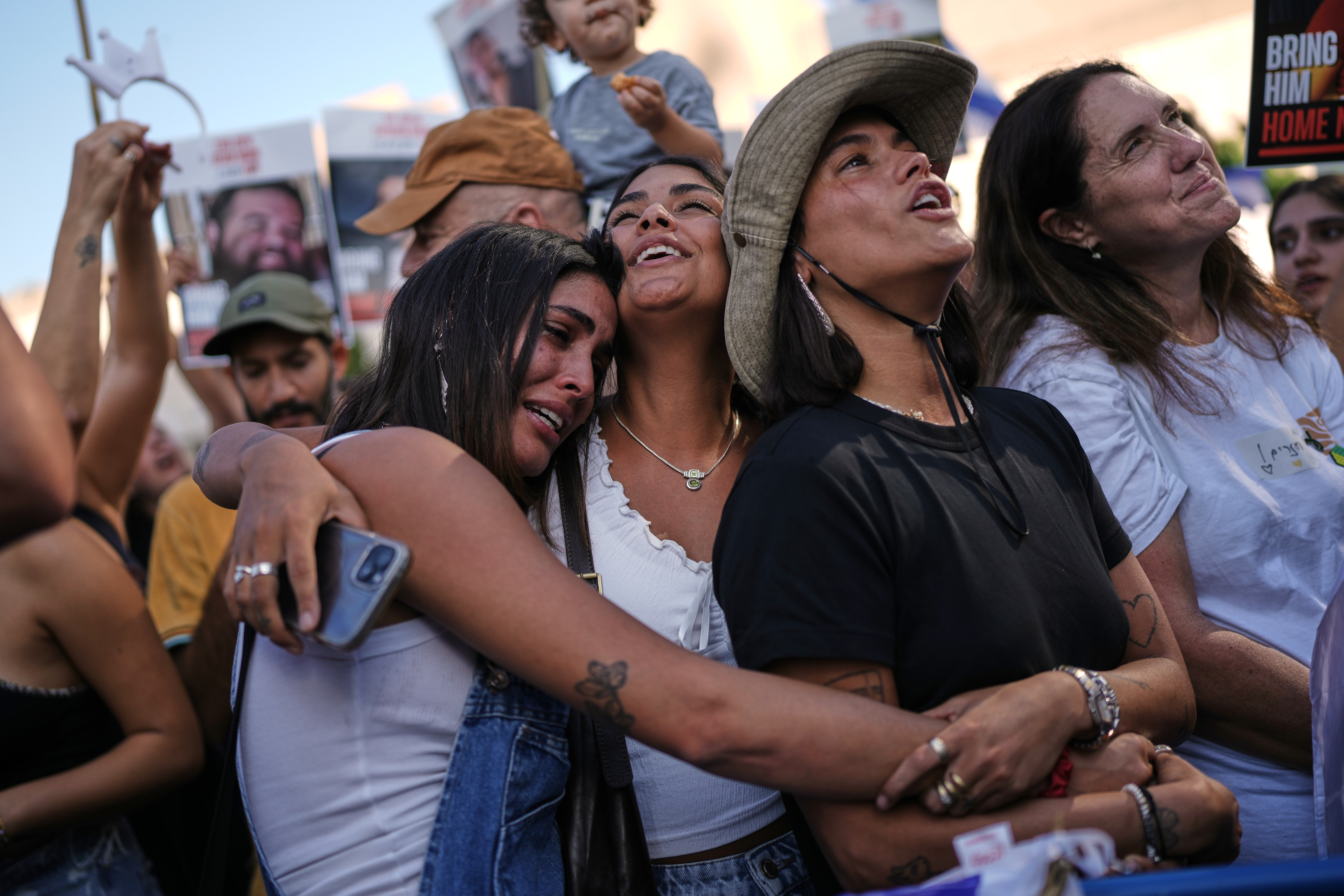 People react as they watch a live broadcast of Israeli hostages released from Gaza in Tel Aviv