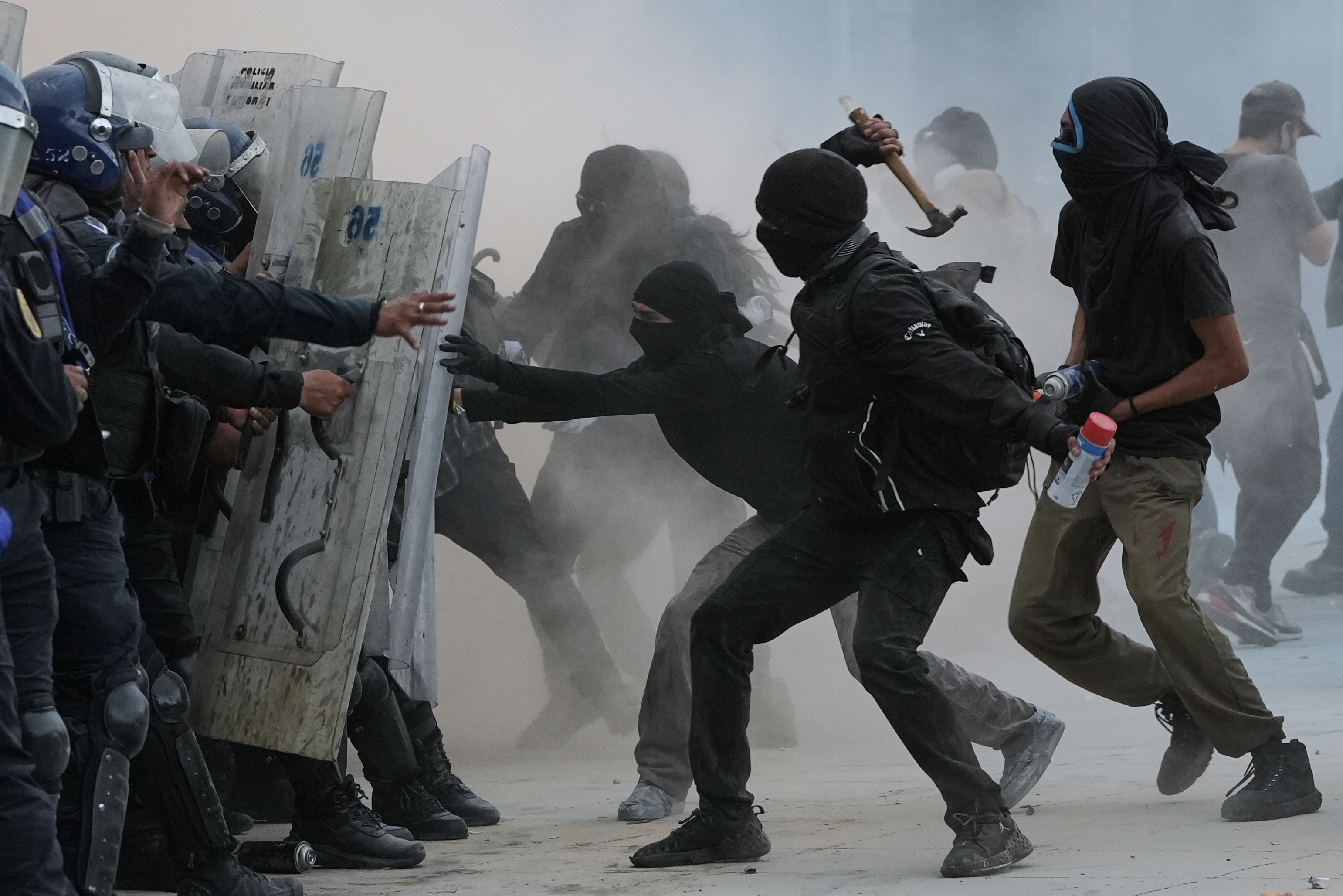 Demonstrators and riot police face off during a protest in Mexico