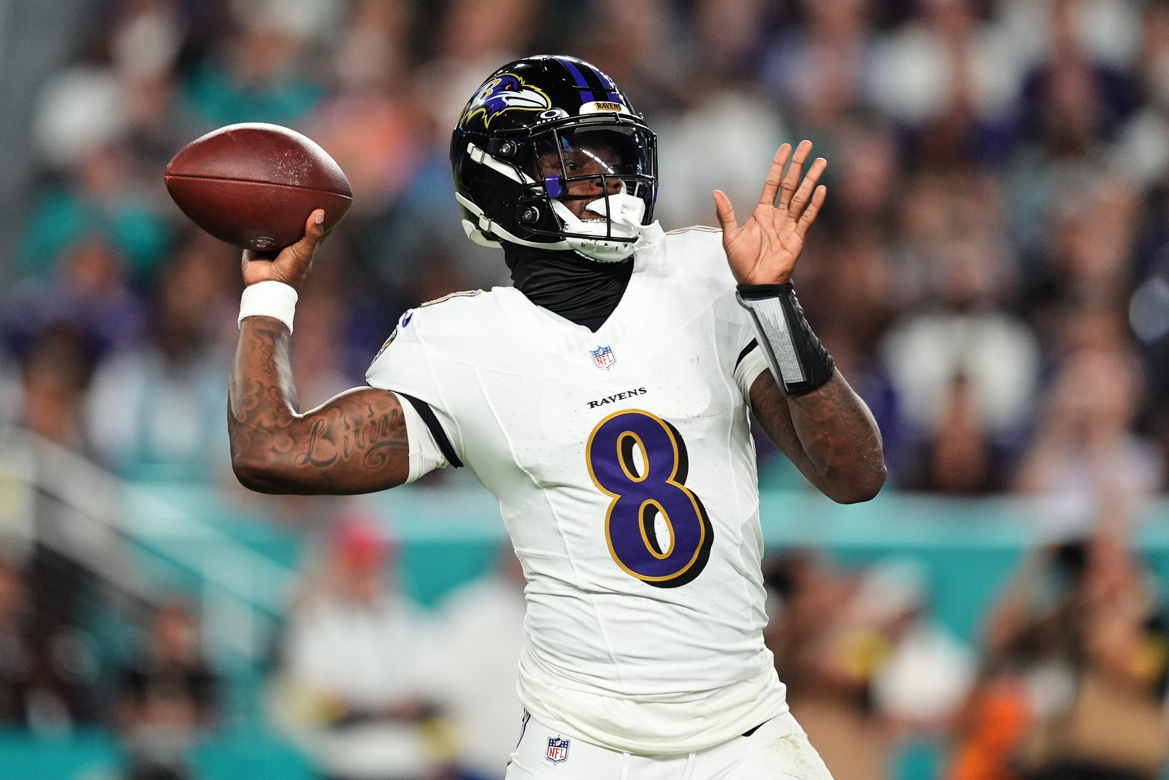 Baltimore Ravens quarterback Lamar Jackson (8) throws against the Miami Dolphins during the first half of an NFL football game, Thursday, in Miami Gardens, Fla.