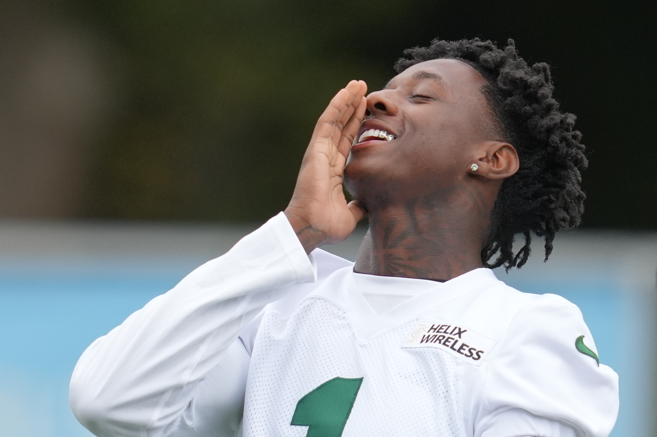 New York Jets cornerback Sauce Gardner (1), gestures during an NFL football practice at The Grove in Watford, England, Friday, Oct. 10, 2025. (AP Photo/Kin Cheung)
