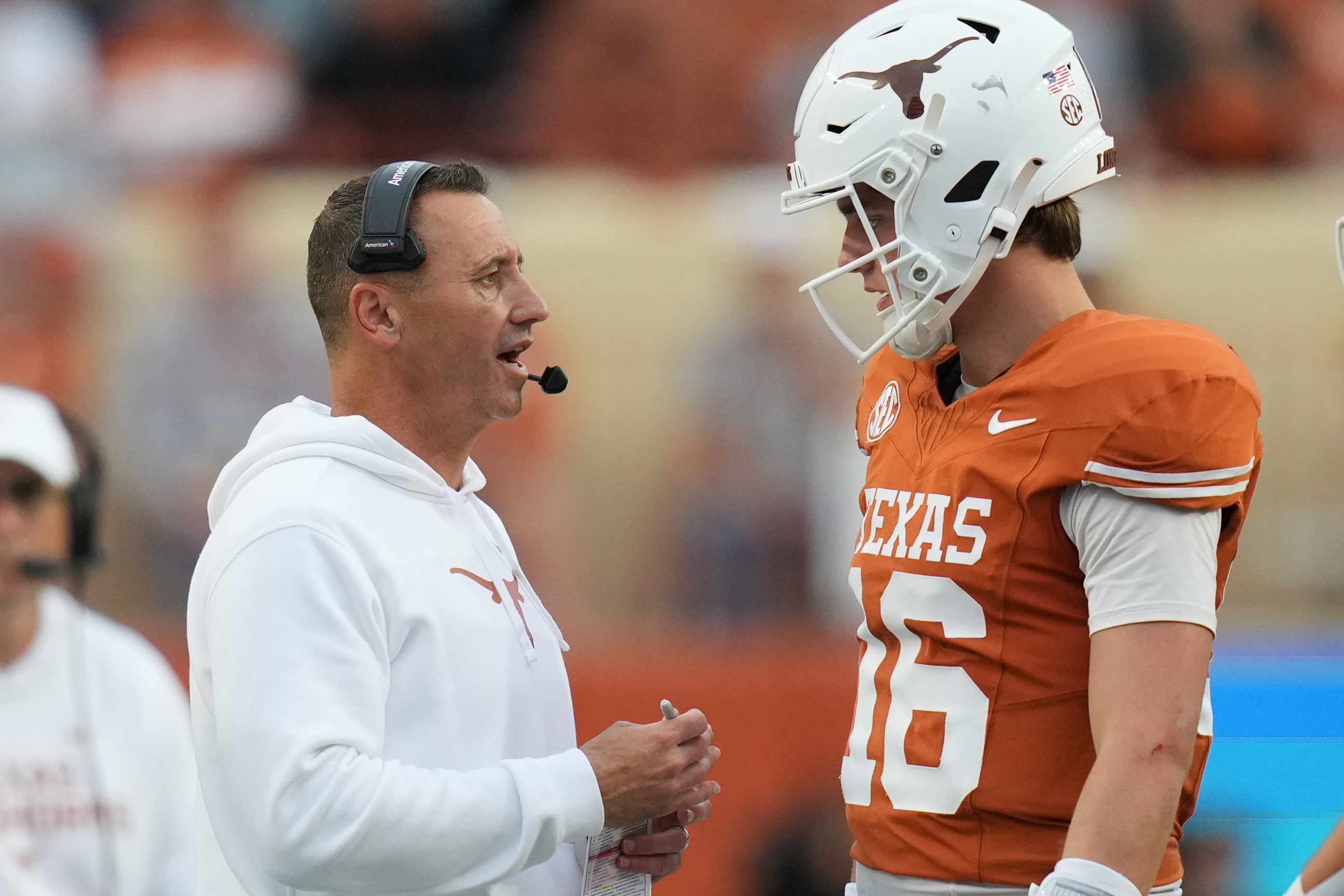 Texas head coach Steve Sarkisian, left, talks with quarterback Arch Manning (16) during the second half of an NCAA college football game against Vanderbilt in Austin, Texas, Saturday, Nov. 1, 2025.