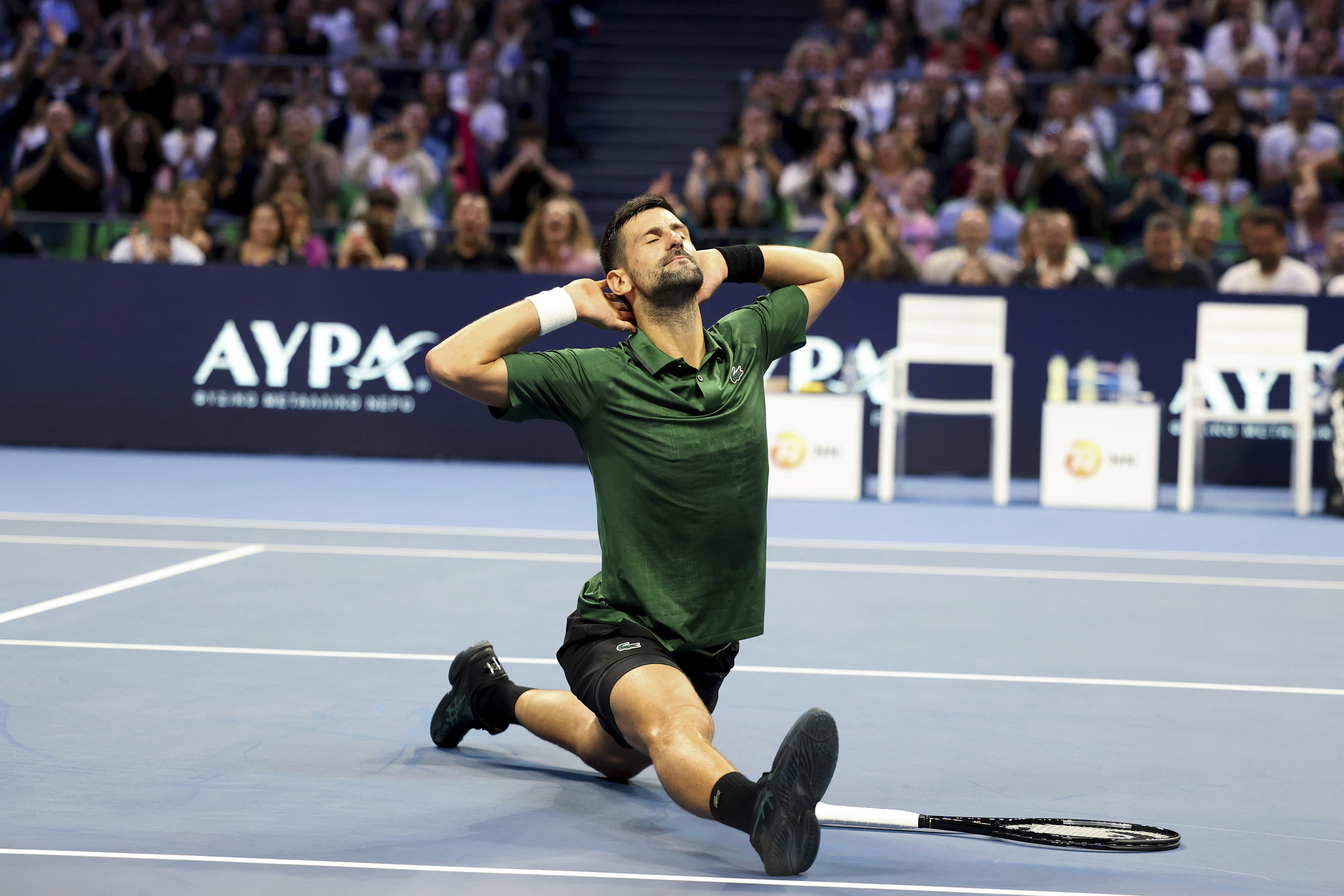 Novak Djokovic of Serbia slides into the splits after returning a ball during an ATP 250 tennis tournament final match in Athens, Greece.