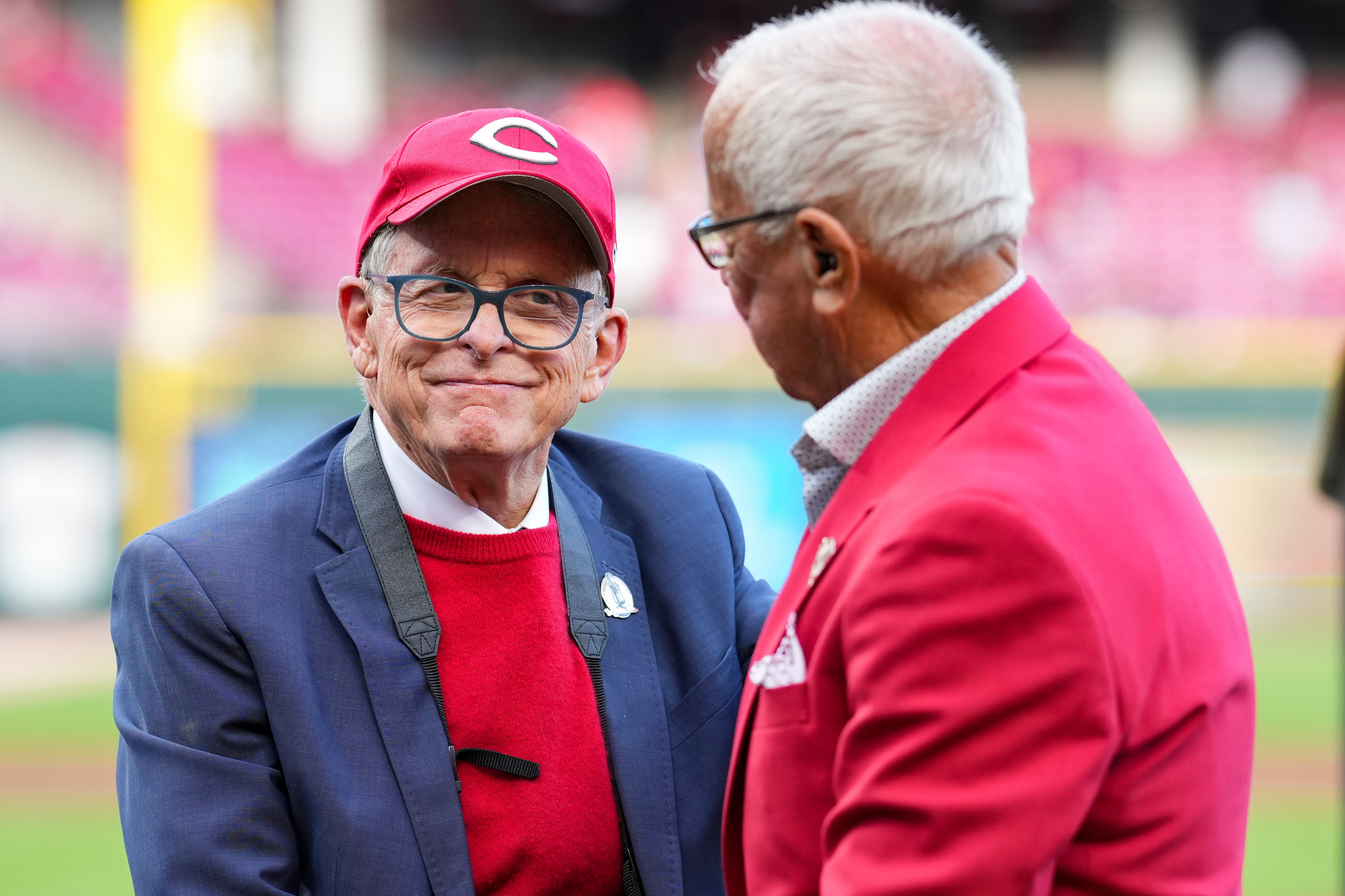 FILE - Hall of Fame broadcaster Marty Brennaman, right, speaks with Ohio Gov. Mike DeWine, left, during 