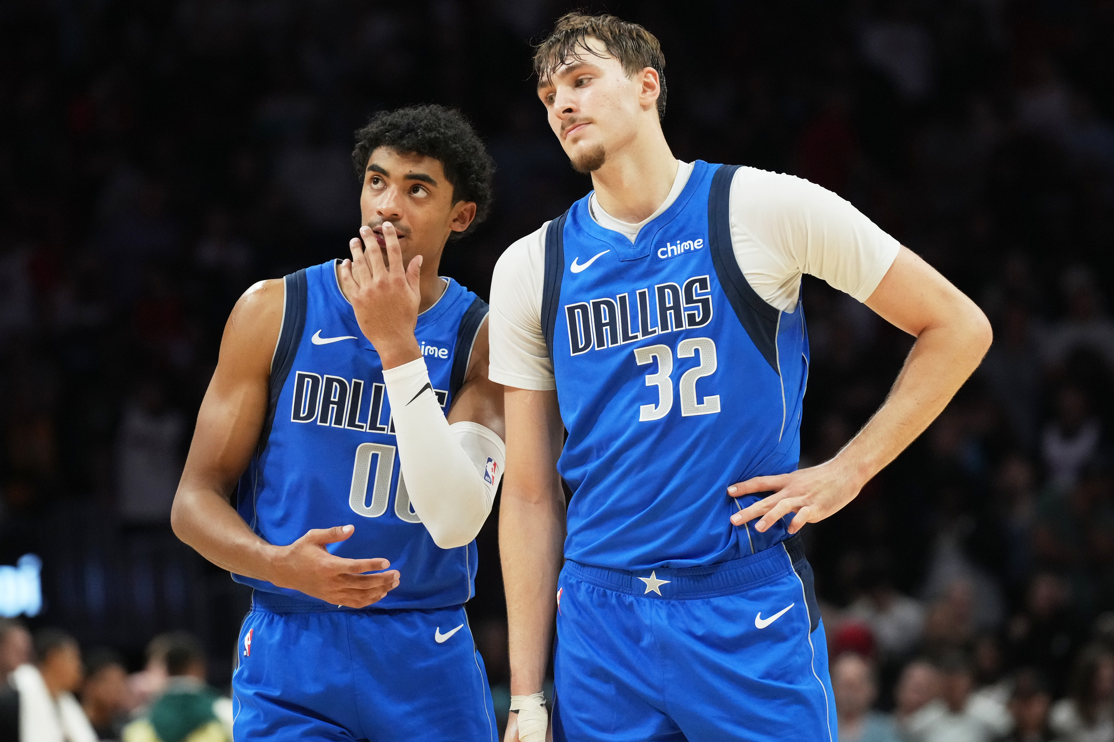 Dallas Mavericks guard Max Christie (00) and forward Cooper Flagg (32) stand together during the last seconds of the second half of an NBA basketball game against the Miami Heat Monday, Nov. 24, 2025, in Miami.