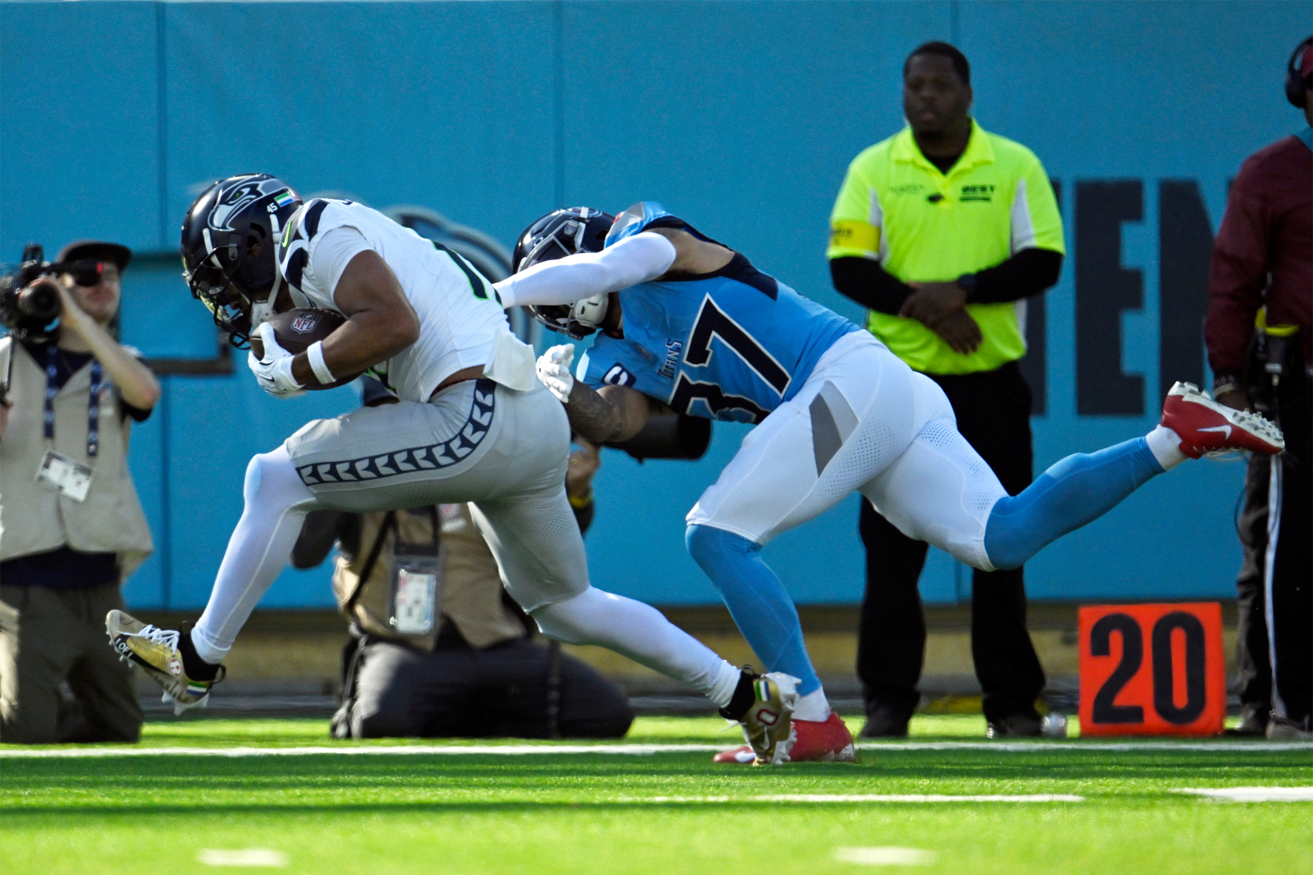 Seattle Seahawks wide receiver Jaxon Smith-Njigba, left, catches a touchdown pass ahead of Tennessee Titans safety Amani Hooker (37) during the first half of an NFL football game Sunday, Nov. 23, 2025, in Nashville, Tenn.