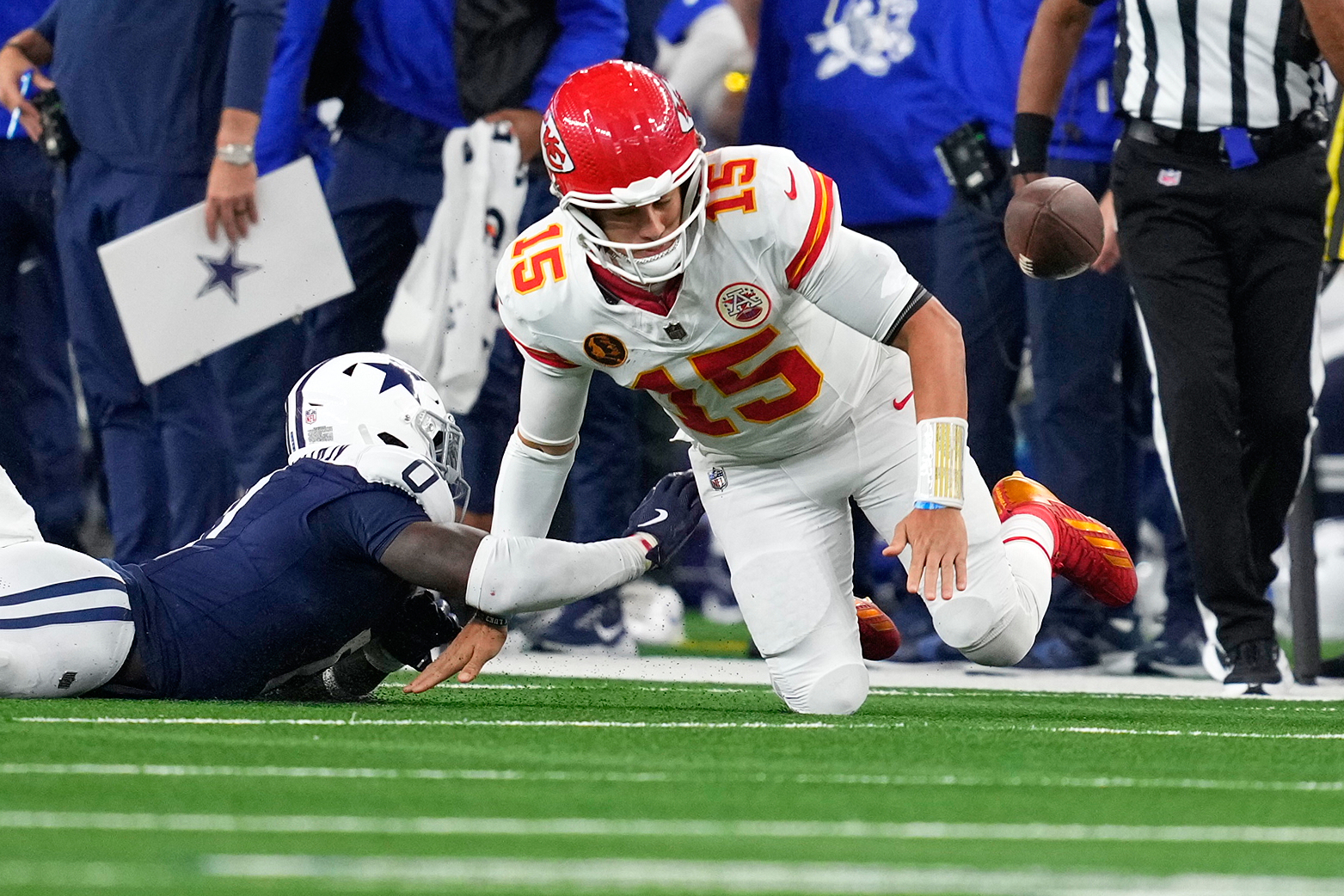 Dallas Cowboys linebacker DeMarvion Overshown, left, knocks the ball out of bounds away from Kansas City Chiefs quarterback Patrick Mahomes during the first half of an NFL football game Thursday, Nov. 27, 2025, in Arlington, Texas.