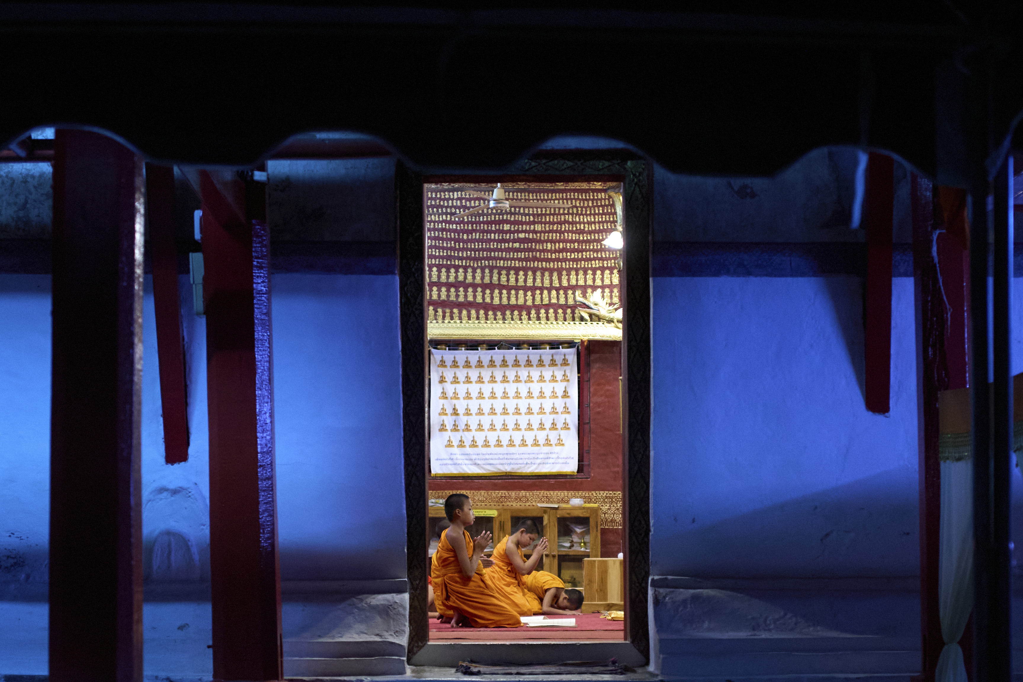 Novice Buddhist monks pray in Luang Prabang, Laos. 