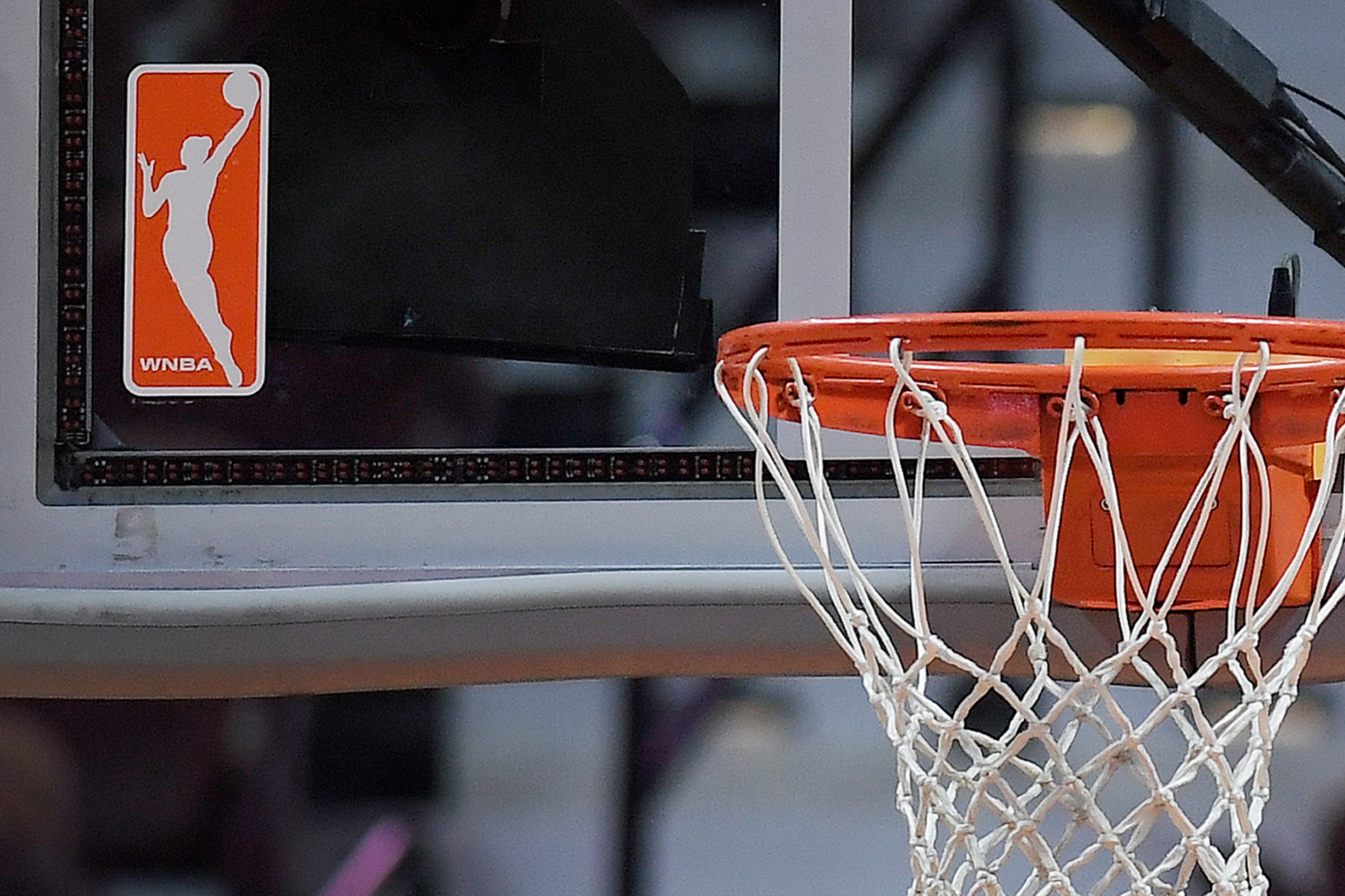 The WNBA logo is seen near a hoop before an WNBA basketball game at Mohegan Sun Arena, May 14, 2019, in Uncasville, Conn. (AP Photo/Jessica Hill, File)