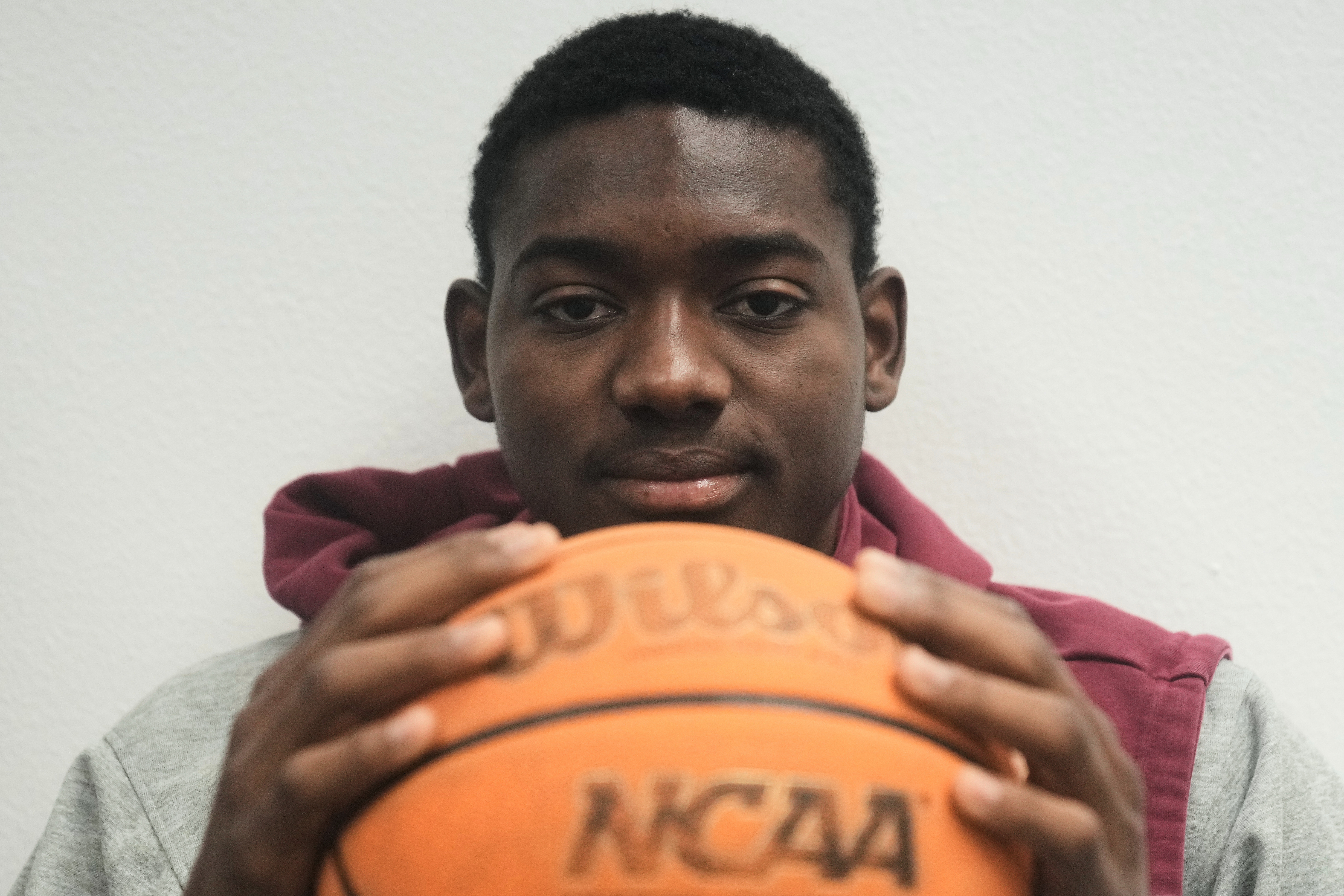 Santa Clara basketball player Thierry Darlan holds a basketall while being interviewed on the Santa Clara University campus in Santa Clara, Calif., Thursday, Nov. 13, 2025. (AP Photo/Jeff Chiu)