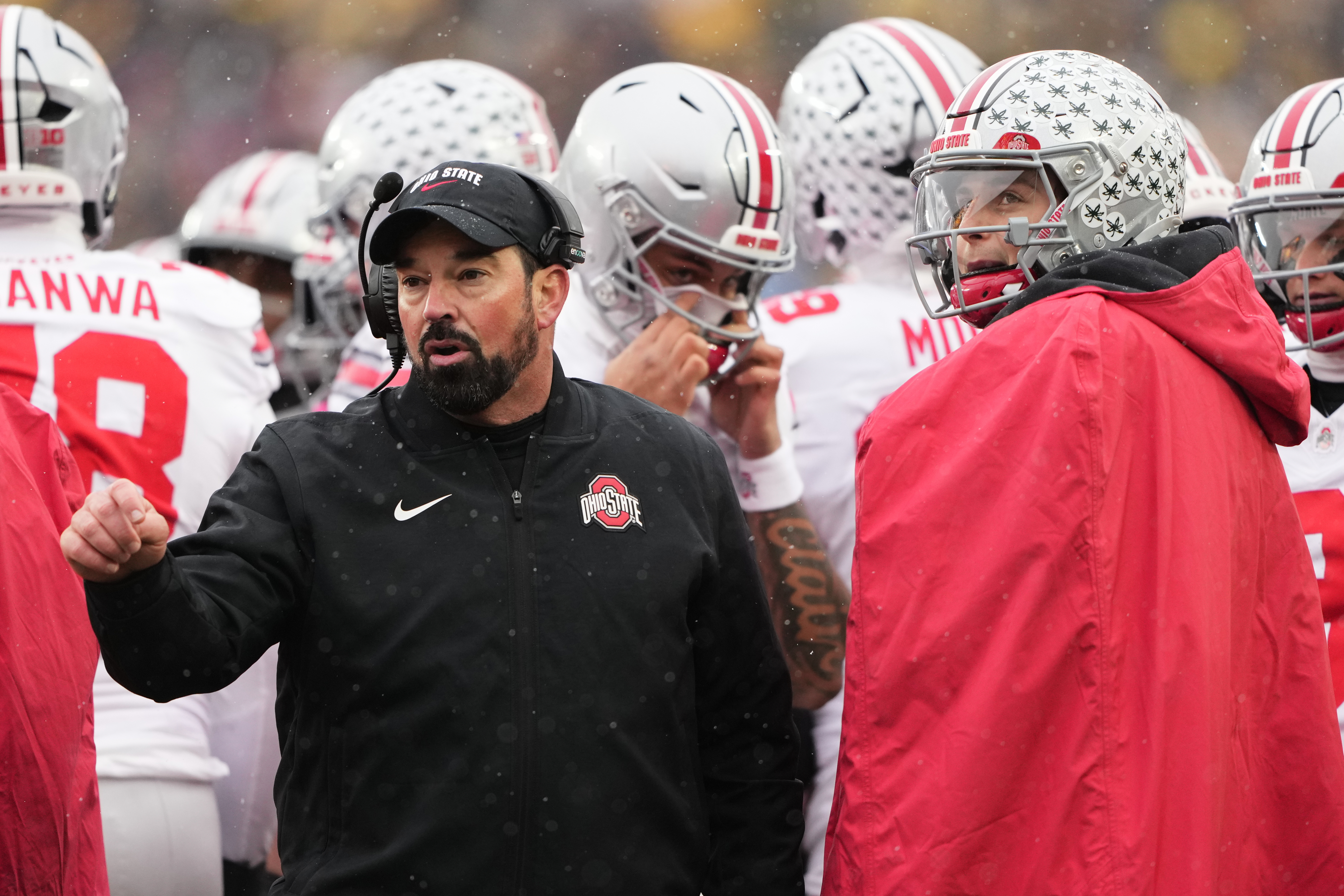 Ohio State head coach Ryan Day, left, speaks with quarterback Julian Sayin during the first half of an NCAA college football game against Michigan, Saturday, Nov. 29, 2025, in Ann Arbor, Mich.
